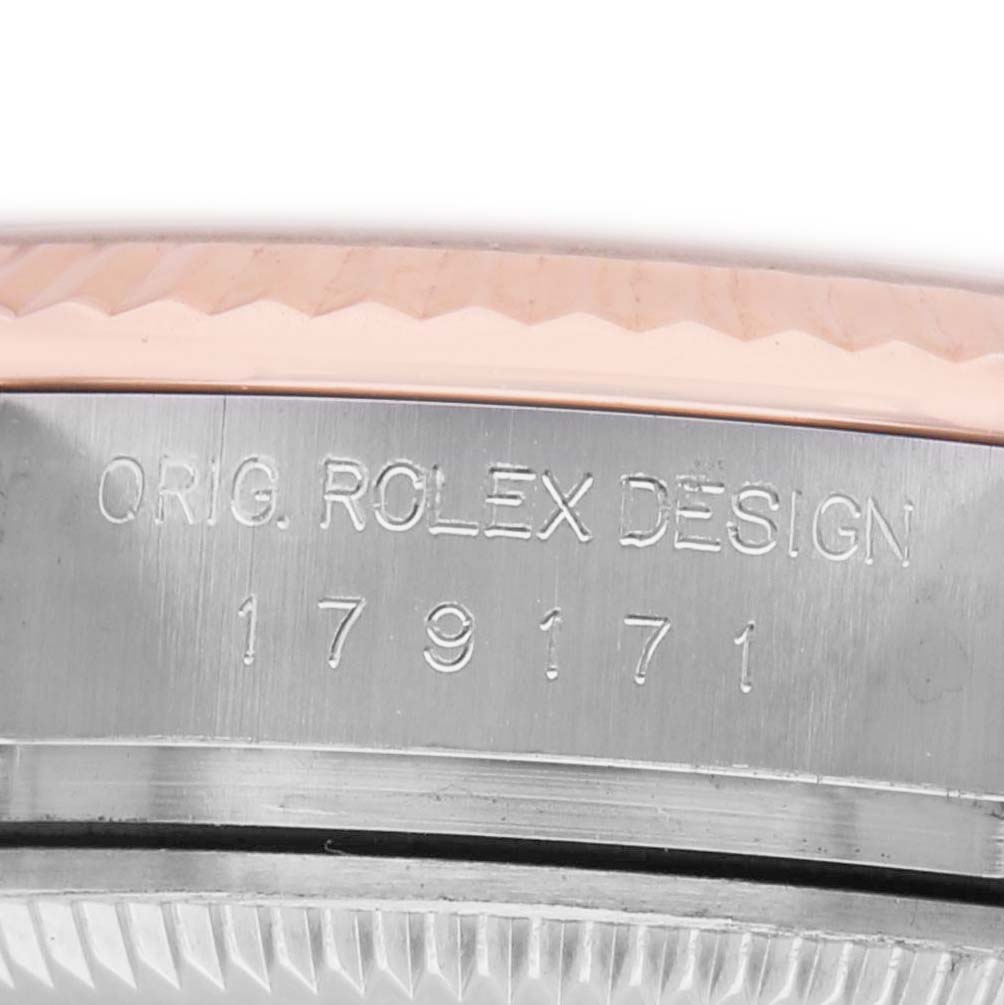 The image shows a close-up of the Rolex Datejust 179171 Women's Stainless Steel Pink Dial's side, highlighting the engraved design and part of the fluted bezel.
