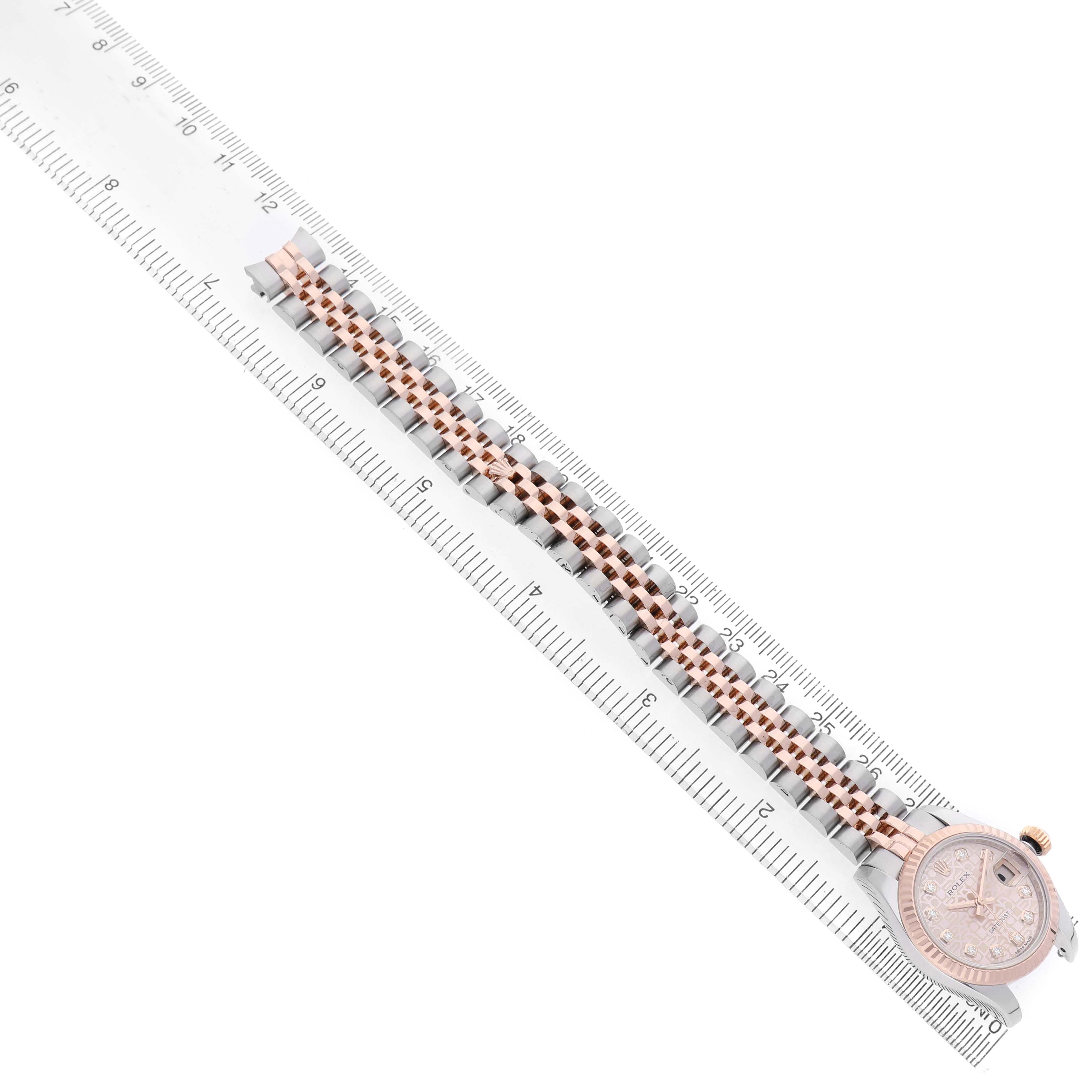 The image shows a Rolex Datejust 179171 Women's Stainless Steel Pink Dial watch laying flat, displaying the band and face alongside a ruler for size reference.