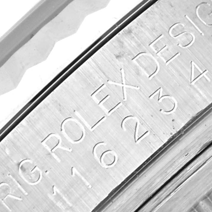 This close-up image shows the engraved serial number and "Rolex Design" inscription on the inner bezel of a Rolex Datejust 116234 Men's Stainless Steel Black Dial 116234 Men's Stainless Steel Black Dial watch.