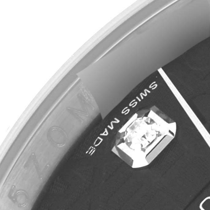 This close-up image shows part of the dial and edge of the bezel of a Rolex Datejust 116234 Men's Stainless Steel Black Dial 116234 Men's Stainless Steel Black Dial model, highlighting a diamond marker and "SWISS MADE" text.