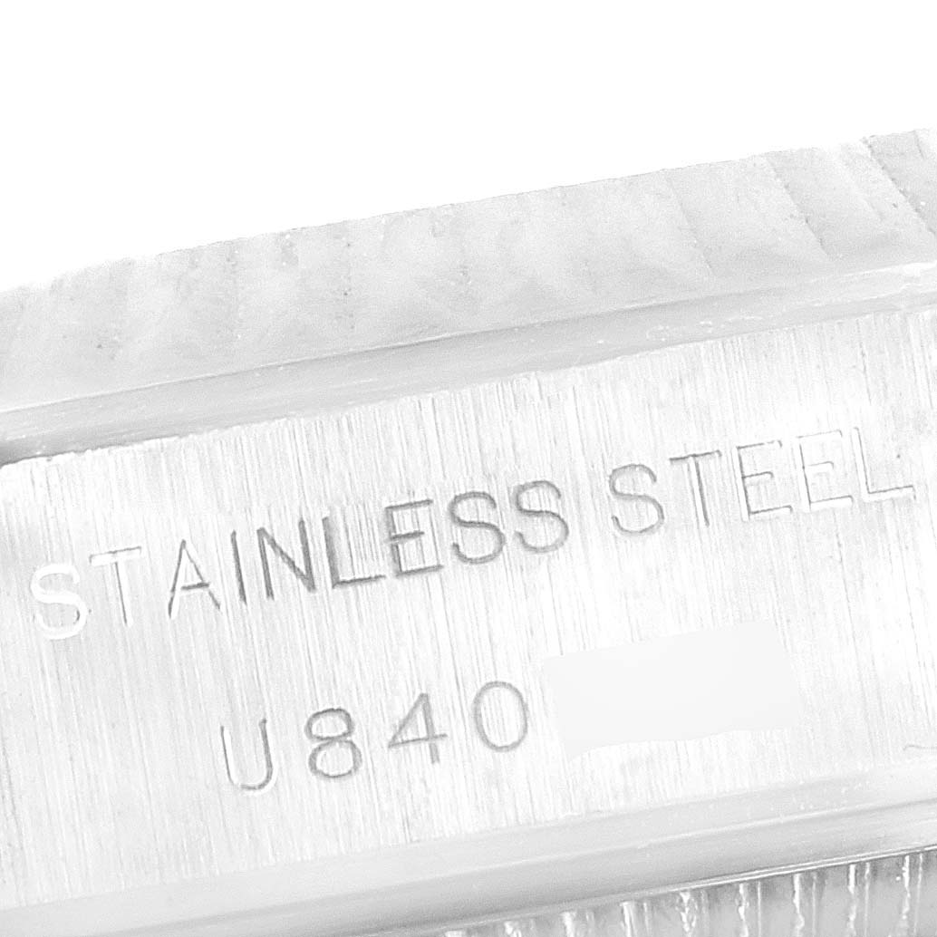 The image shows an engraving on the stainless steel case back of a Rolex Datejust 69174 Women
s Stainless Steel Blue Dial 69174 Women
s Stainless Steel Blue Dial watch.