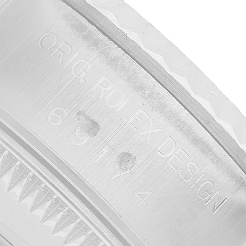 The image shows a close-up of the engraved bezel and case section of a Rolex Datejust 69174 Women's Stainless Steel Pink Dial watch.