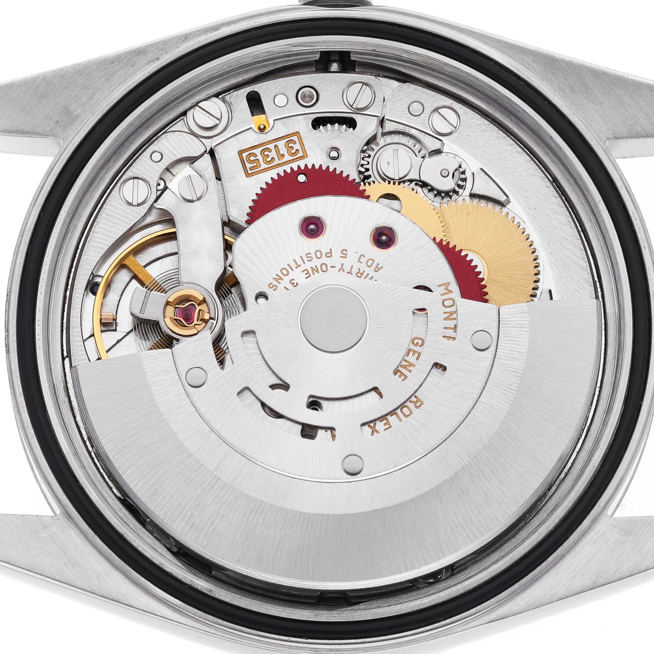 The image shows the movement of a Rolex Datejust 16234 Men's Stainless Steel Silver Dial watch from a top-down angle, revealing intricate gears and components.
