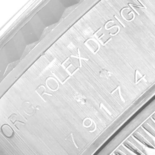 This image shows a close-up of the model number and "ROLEX DESIGN" engraving on the side of a Rolex Datejust 79174 Women's Stainless Steel Mother of Pearl Dial 79174 Women's Stainless Steel Mother of Pearl Dial watch case.