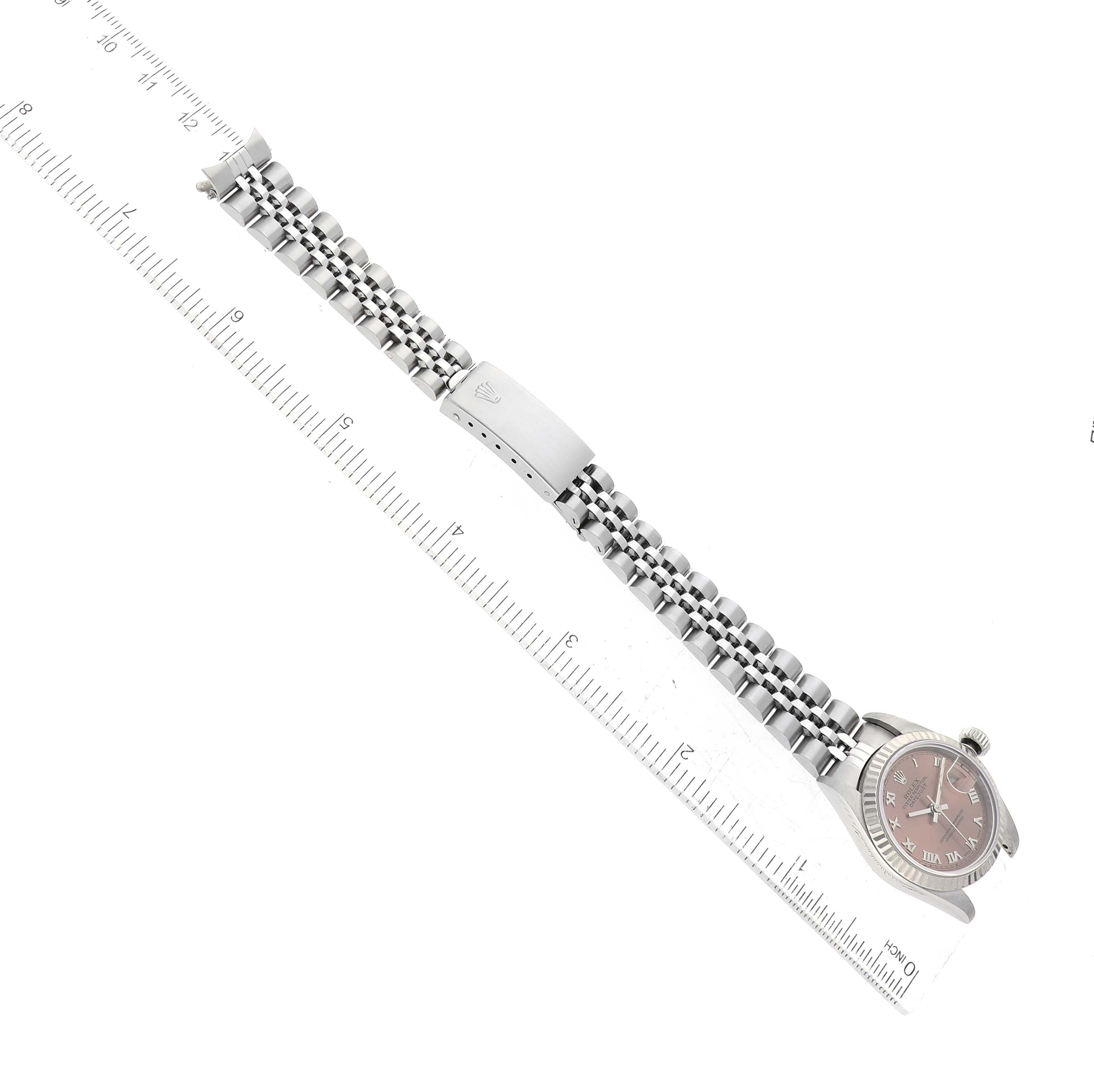 The image shows a Rolex Datejust 69174 Women's Stainless Steel Pink Dial 69174 Women's Stainless Steel Pink Dial watch laid horizontally, focusing on the bracelet and clasp, next to a ruler for size reference.