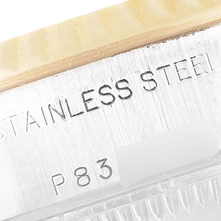 This close-up image shows part of the case with "STAINLESS STEEL" text engraved on a Rolex Datejust 79173 Women
s Steel and Gold (two tone) Black Dial 79173 Women
s Steel and Gold (two tone) Black Dial watch.