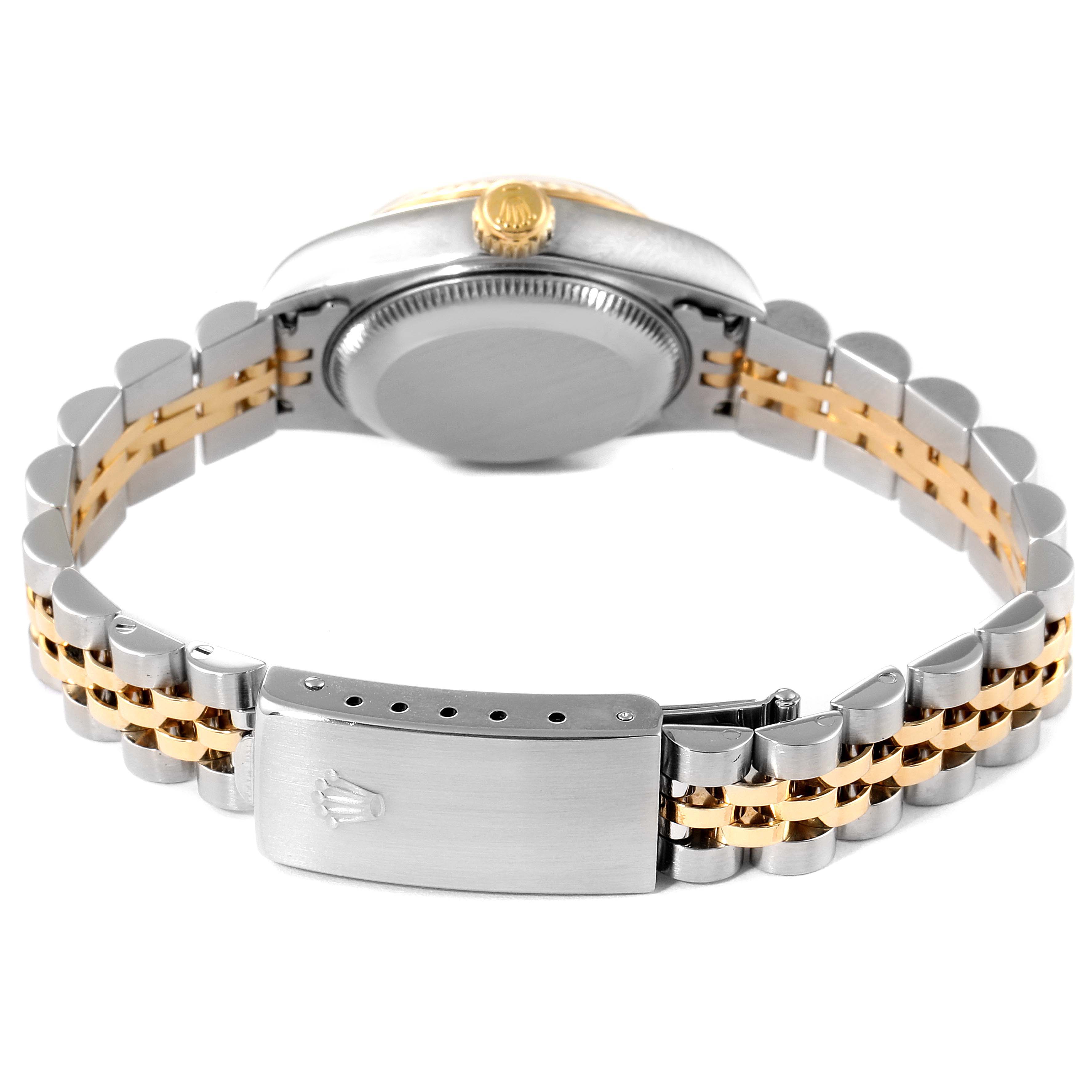 The image shows the back of a Rolex Datejust 79173 Women
s Steel and Gold (two tone) Black Dial 79173 Women
s Steel and Gold (two tone) Black Dial watch, highlighting its two-tone bracelet and clasp.