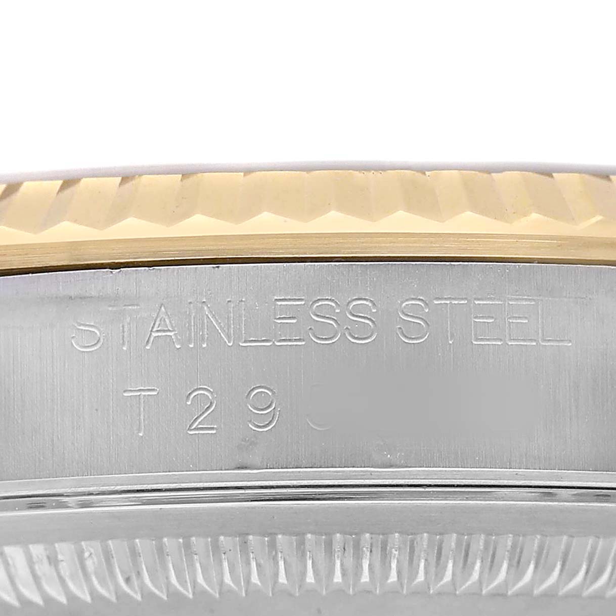 The image shows a close-up of the side bezel and case edge of a Rolex Datejust 16233 Men's Stainless Steel Champagne Dial, with "STAINLESS STEEL" engraved.