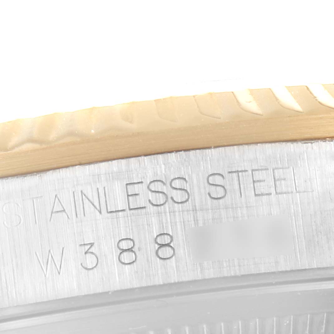 This is a close-up of the side engraving and bezel of a Rolex Datejust 16233 Men's Steel and Gold (two tone) Champagne Dial 16233 Men's Steel and Gold (two tone) Champagne Dial watch.