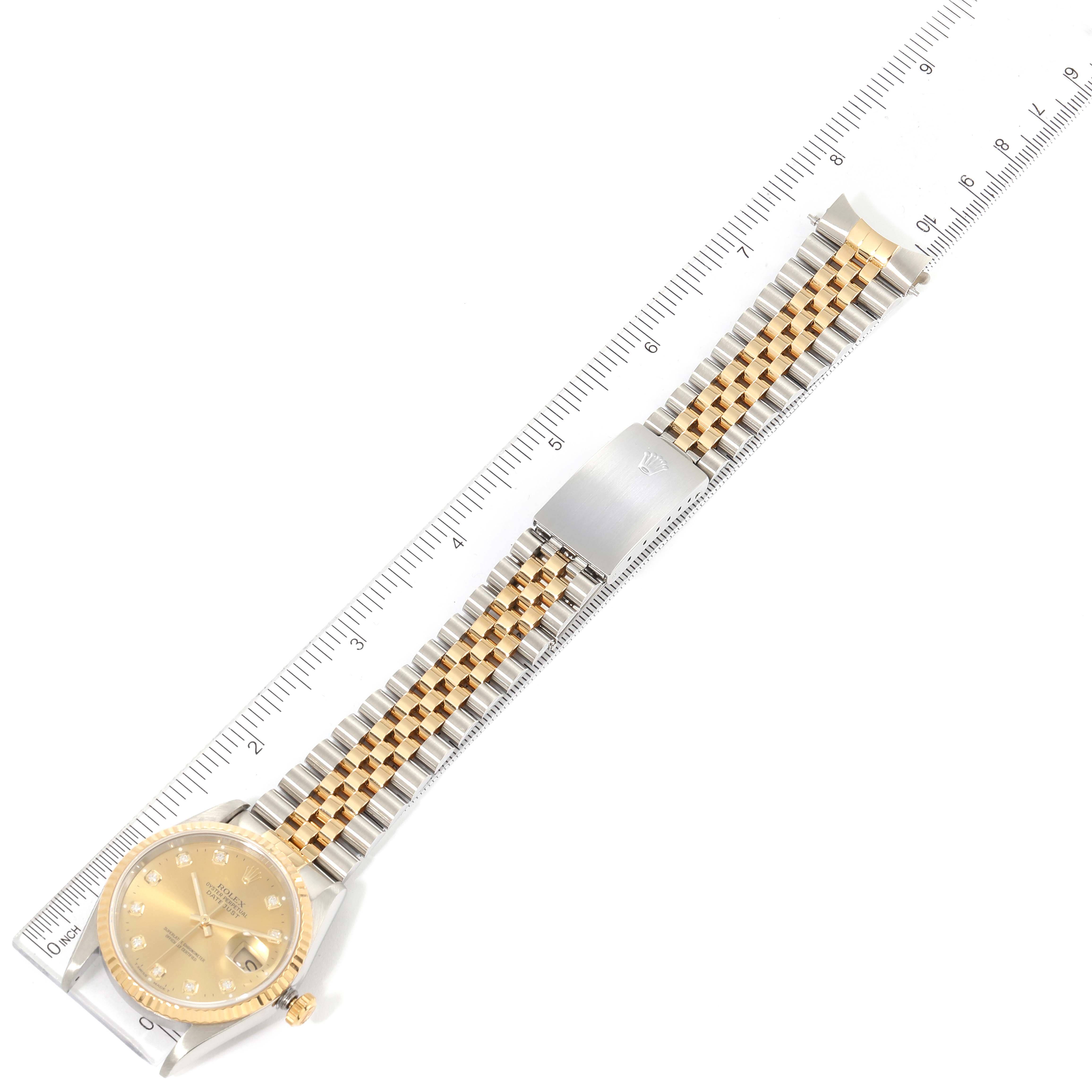 The image shows a Rolex Datejust 16233 Men's Steel and Gold (two tone) Champagne Dial 16233 Men's Steel and Gold (two tone) Champagne Dial watch in a flat, overhead view, including the face, bracelet, and clasp placed alongside a ruler.