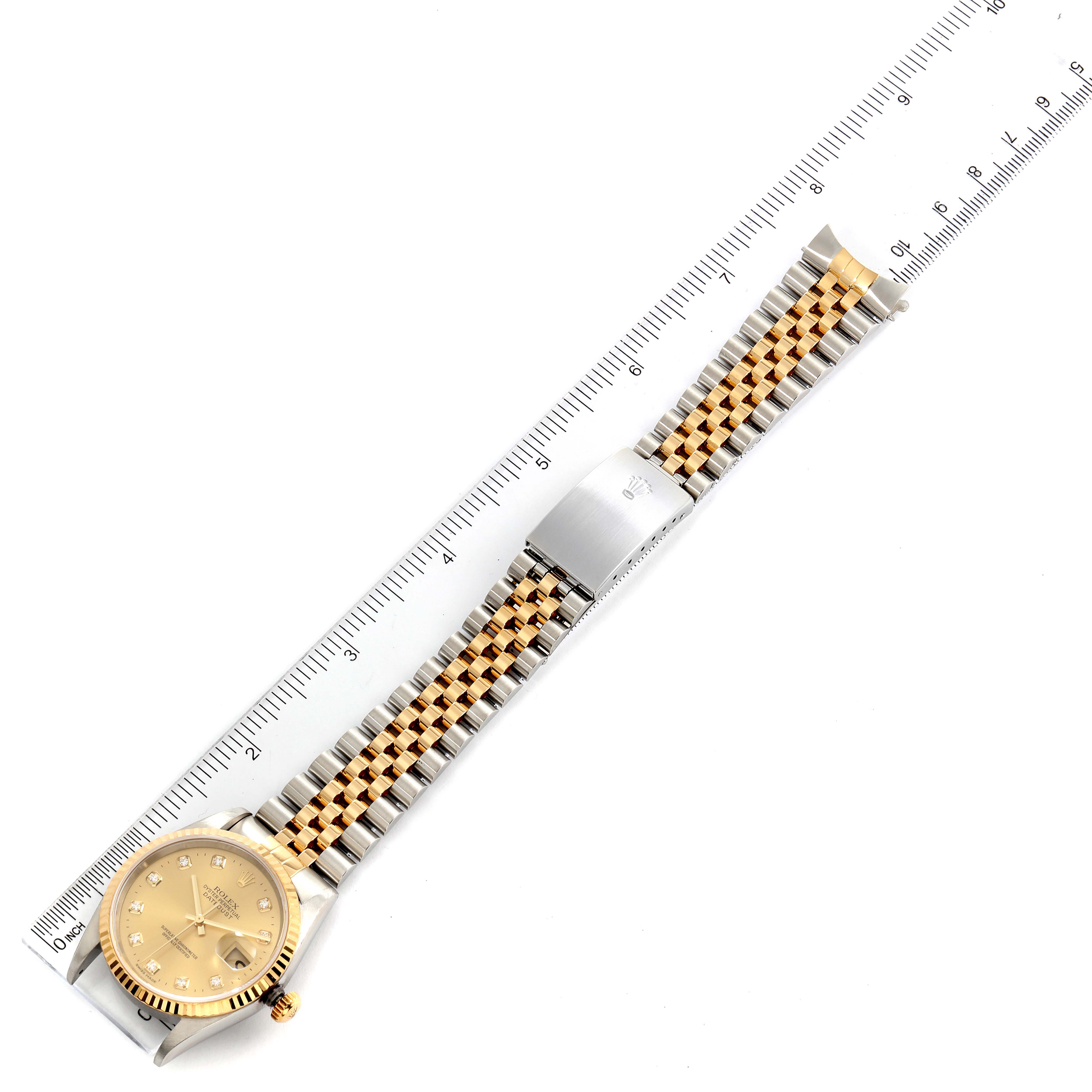 The image shows a Rolex Datejust 16233 Men's Steel and Gold (two tone) Champagne Dial 16233 Men's Steel and Gold (two tone) Champagne Dial model watch laid flat with both sides of the bracelet visible next to a ruler for measurement.