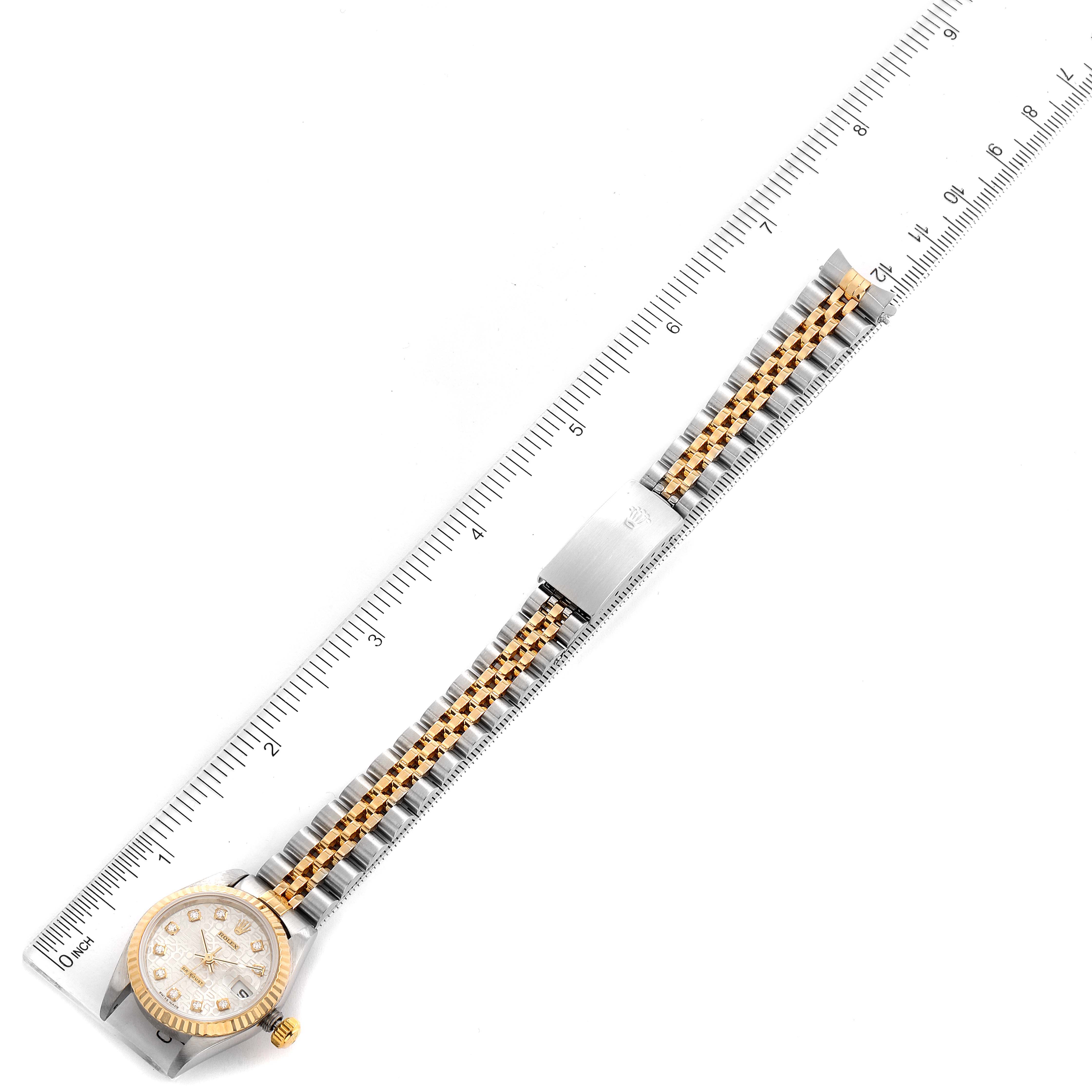The image shows the Rolex Datejust 79173 Women's Steel and Gold (two tone) Silver Dial 79173 Women's Steel and Gold (two tone) Silver Dial watch laid flat with a ruler for scale, highlighting the full bracelet and face.