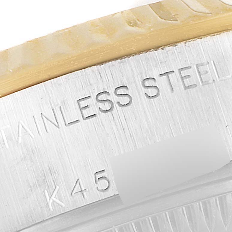 This close-up shows the edge of the bezel and part of the engraved case back of the Rolex Datejust 79173 Women's Steel and Gold (two tone) Silver Dial 79173 Women's Steel and Gold (two tone) Silver Dial watch.