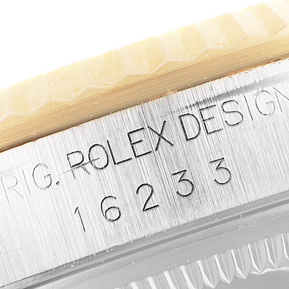 This close-up image shows the side engraving on a Rolex Datejust 16233 Men's Steel and Gold (two tone) Mother of Pearl Dial 16233 Men's Steel and Gold (two tone) Mother of Pearl Dial model, featuring the brand name and model number.