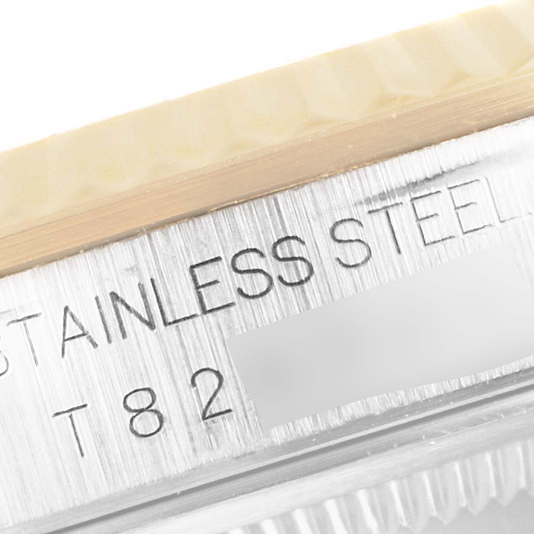 Close-up of the case side of a Rolex Datejust 16233 Men's Steel and Gold (two tone) Mother of Pearl Dial 16233 Men's Steel and Gold (two tone) Mother of Pearl Dial watch showing the engraving "STAINLESS STEEL" and the reference number.