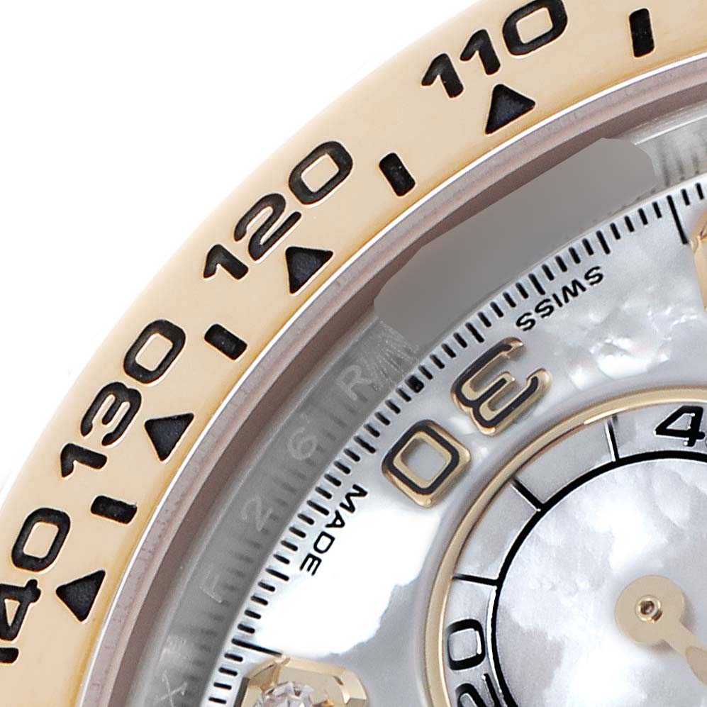 The image shows a close-up of the Rolex Daytona 116503 Men
s Steel and Gold (two tone) Mother of Pearl Dial
s bezel with tachymetric scale and part of the dial.