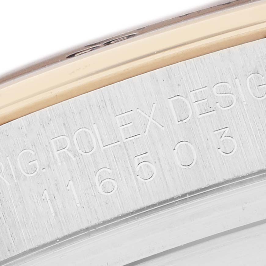 The image shows a close-up of the Rolex Daytona 116503 Men
s Steel and Gold (two tone) Mother of Pearl Dial model
s engraved case side with "Rolex Design" and model number.
