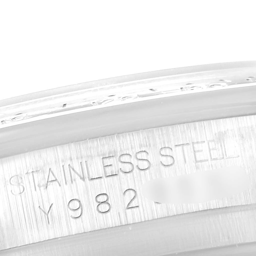 This image shows a close-up view of the stainless steel case engraving on a Rolex Daytona 116520 Men's Stainless Steel White Dial 116520 Men's Stainless Steel White Dial watch.