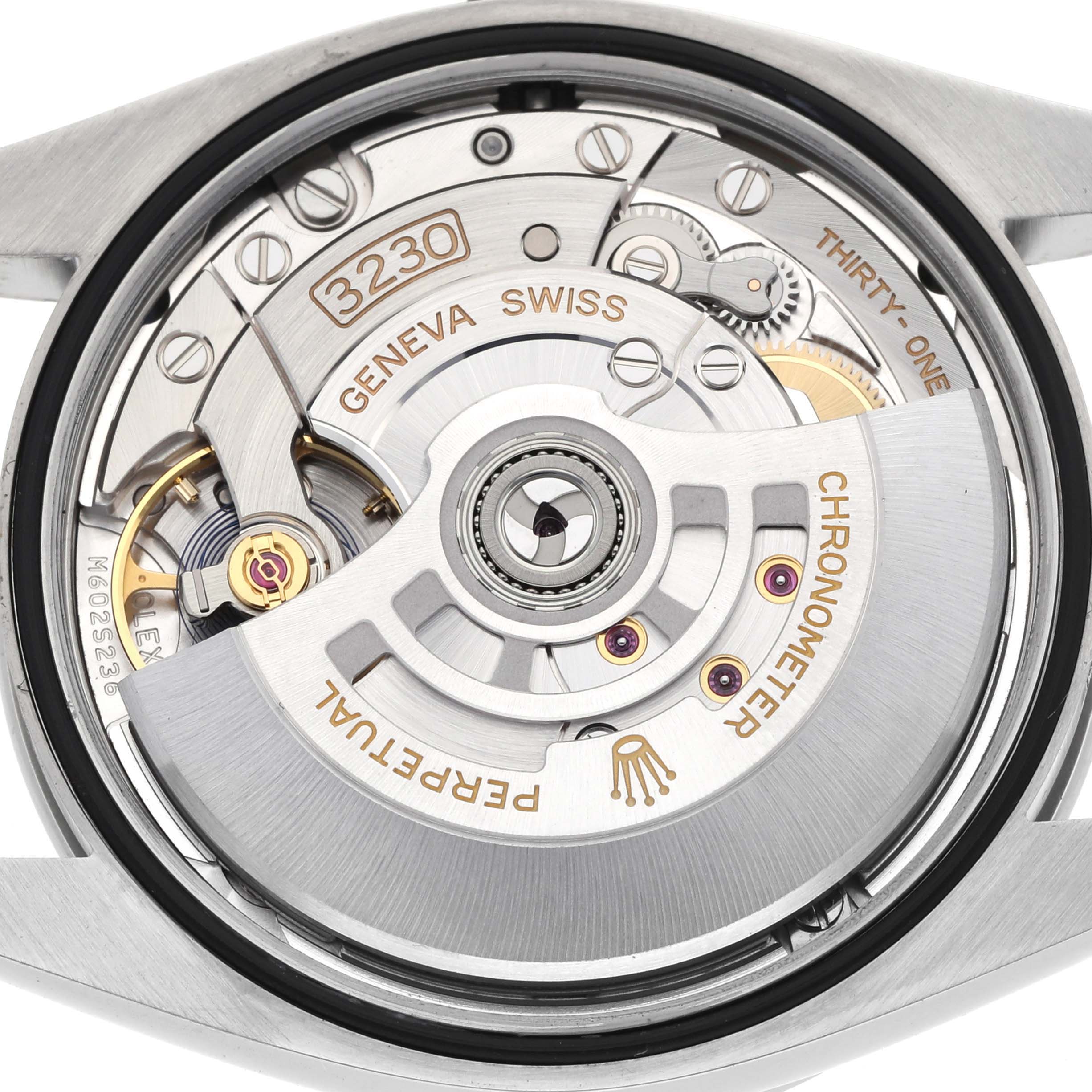 The image shows the back view of a Rolex Explorer 124270 Men
s Stainless Steel Black Dial, highlighting the movement and rotor with "PERPETUAL" and "3230" markings.
