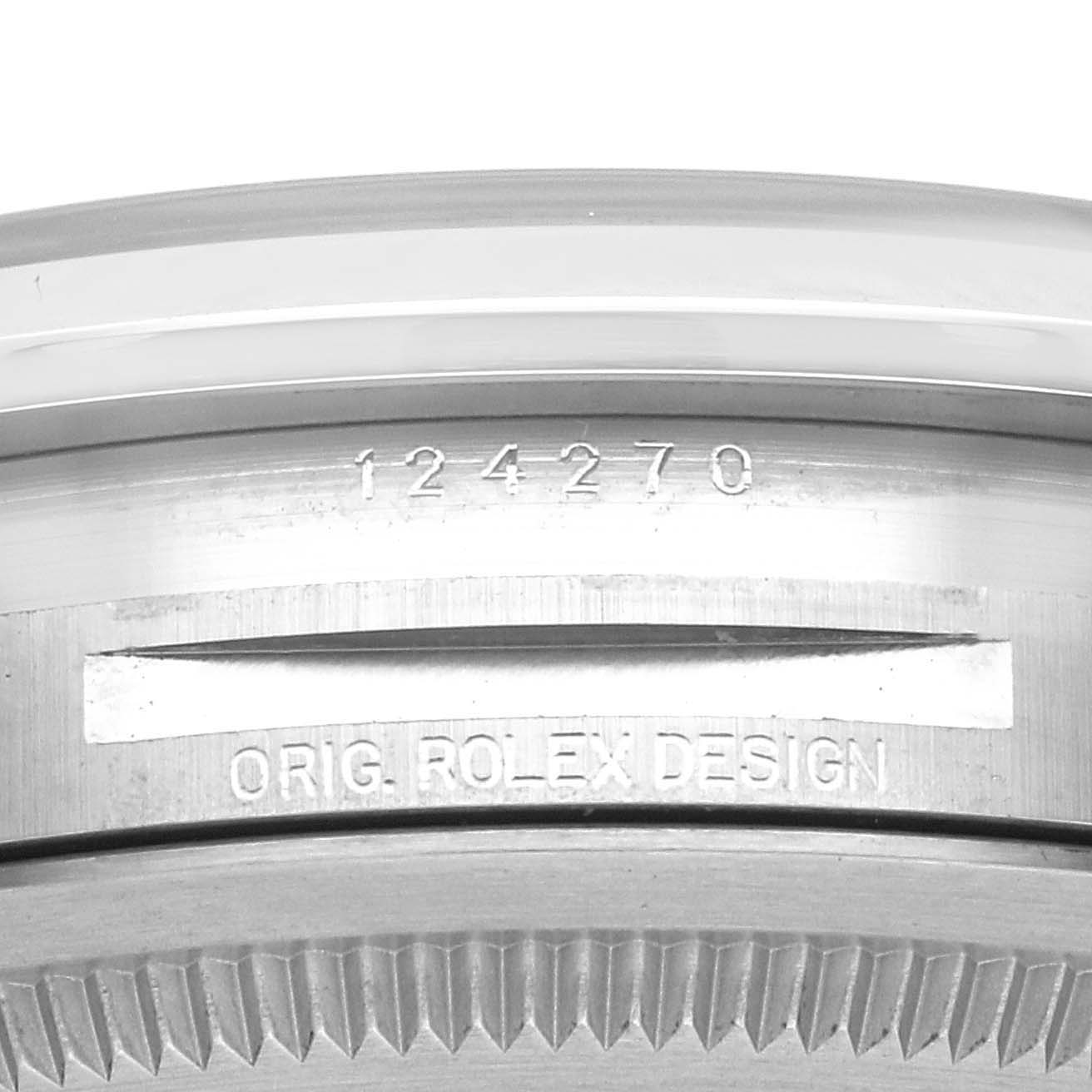 The image shows the side engraving and bezel edge of a Rolex Explorer 124270 Men
s Stainless Steel Black Dial, displaying the model number and "Orig. Rolex Design."