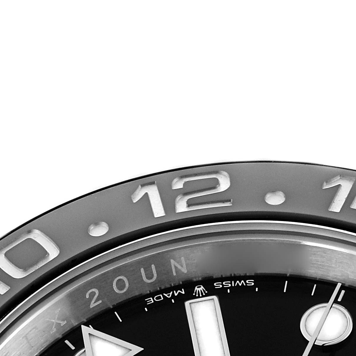 The image shows a close-up of the Rolex GMT-Master 126710 Men
s Stainless Steel Black Dial
s bezel and partial dial, highlighting the 12-hour marking.