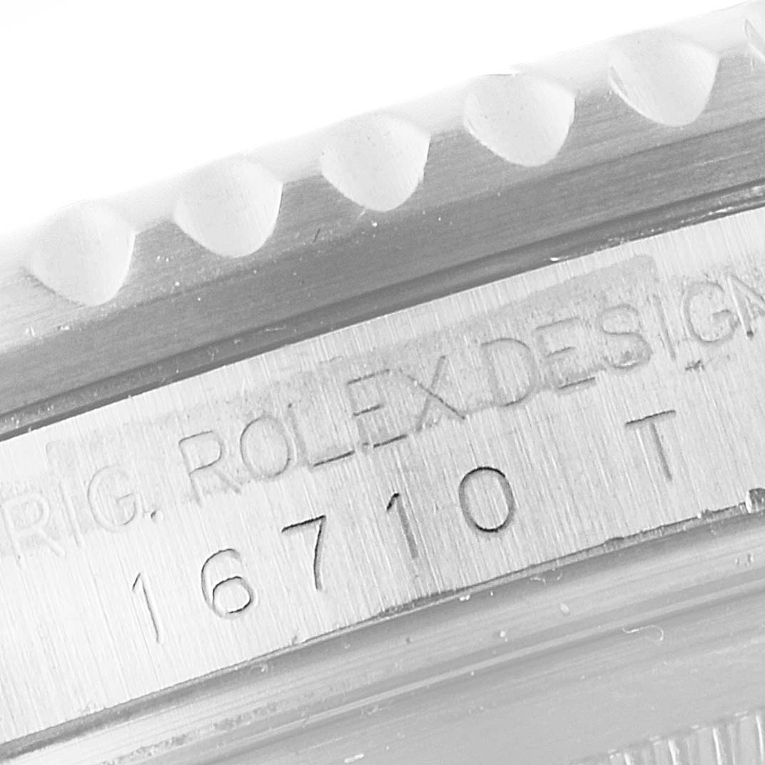 The image shows a close-up angle of the case side of a Rolex GMT-Master 16710 Men
s Stainless Steel Black Dial 16710 Men
s Stainless Steel Black Dial watch, focusing on the engraved model number and part of the bezel.