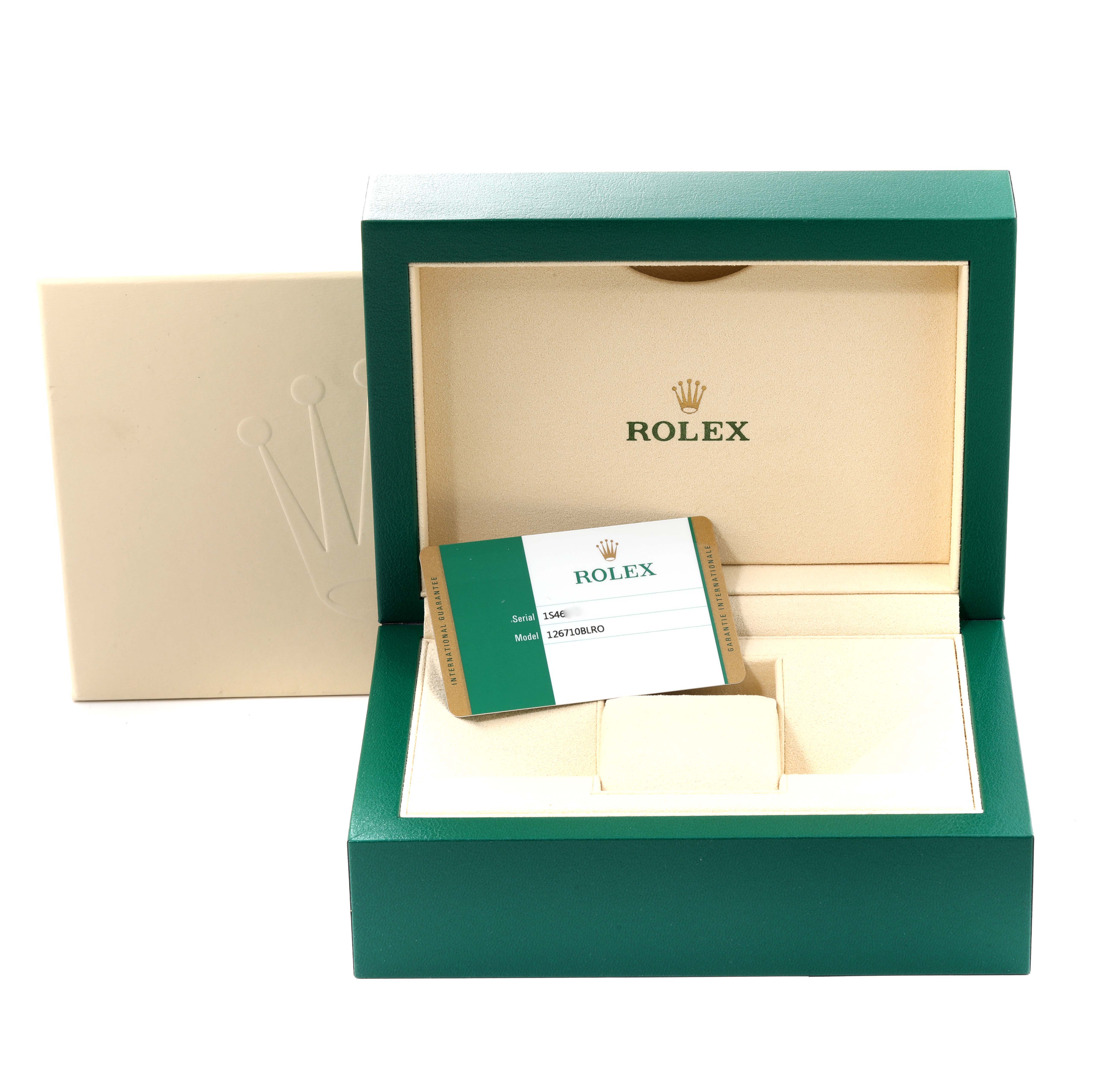 This image shows an empty Rolex GMT-Master 126710BLRO Men's Stainless Steel Black Dial 126710BLRO Men's Stainless Steel Black Dial watch box at an angled view, displaying the interior and a serial/model card.