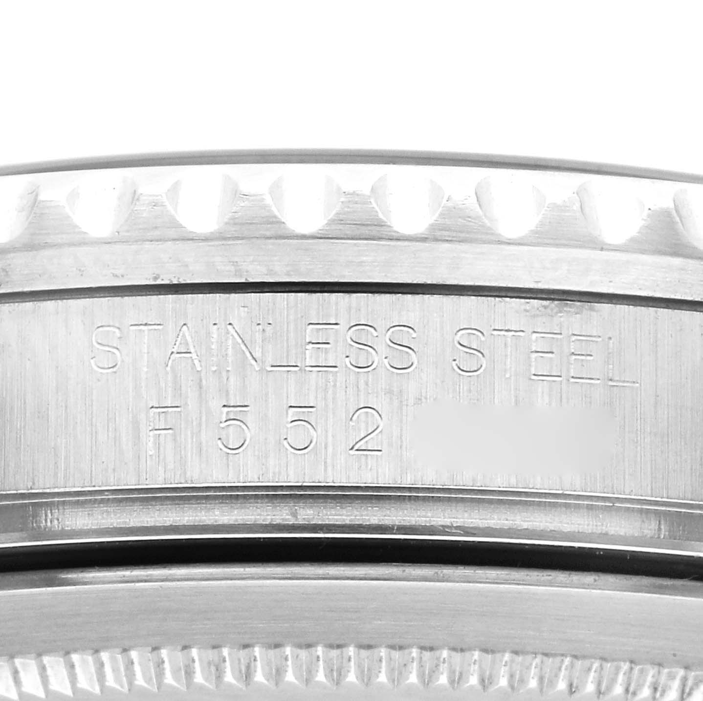 This image shows the side of a Rolex GMT-Master 16710 Men's Stainless Steel Black Dial 16710 Men's Stainless Steel Black Dial watch with an engraving on its stainless steel case.