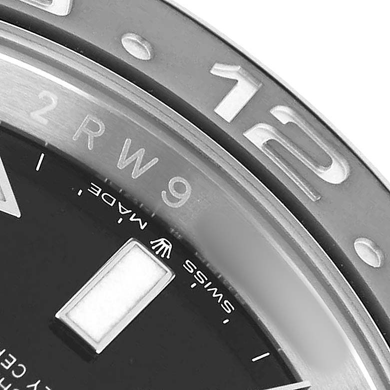 The image shows a close-up of the Rolex GMT-Master 126710 Men's Stainless Steel Black Dial's bezel, dial, and part of the hour marker at an oblique angle.