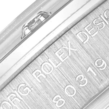 This image shows a close-up of the side engraving on the case of a Rolex Pearlmaster 80319 Women's White Gold Mother of Pearl Dial 80319 Women's White Gold Mother of Pearl Dial watch.