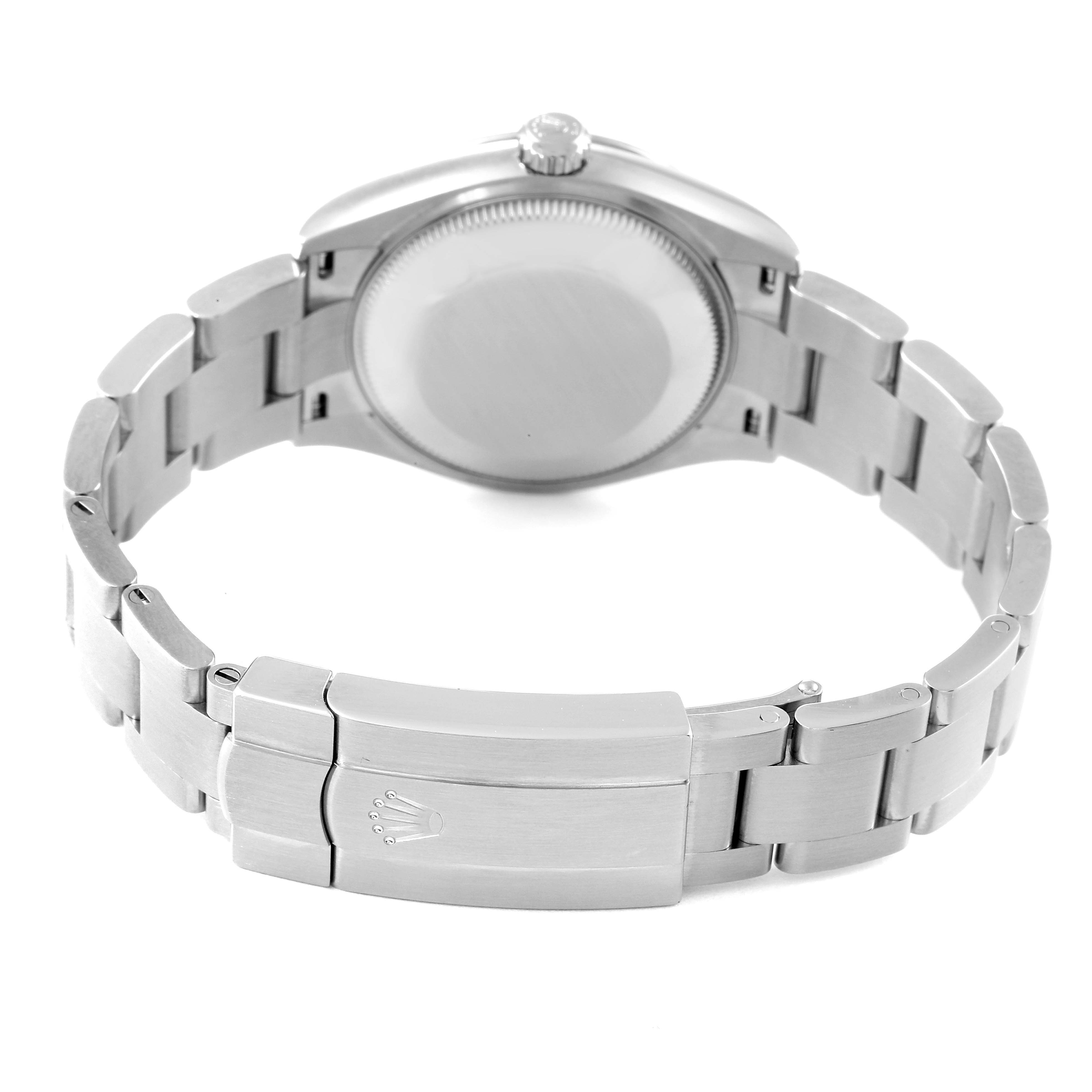 The image shows the back view of a Mid-Size Rolex watch, highlighting its case back and metal bracelet with the clasp.