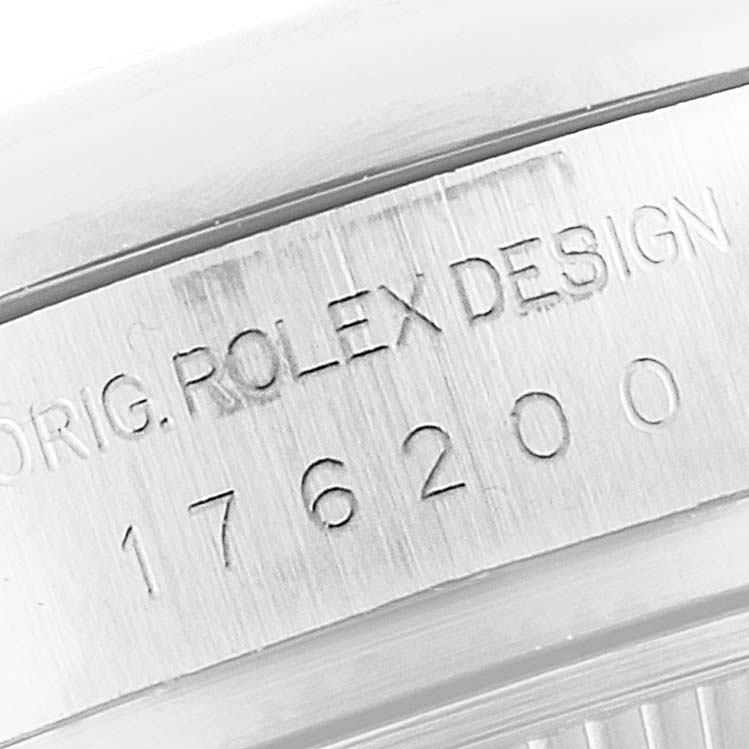 This image shows a close-up of the engraved serial number and "ROLEX DESIGN" text on the side of a Rolex Oyster Perpetual 176200 Women
s Stainless Steel Pink Dial 176200 Women
s Stainless Steel Pink Dial watch.