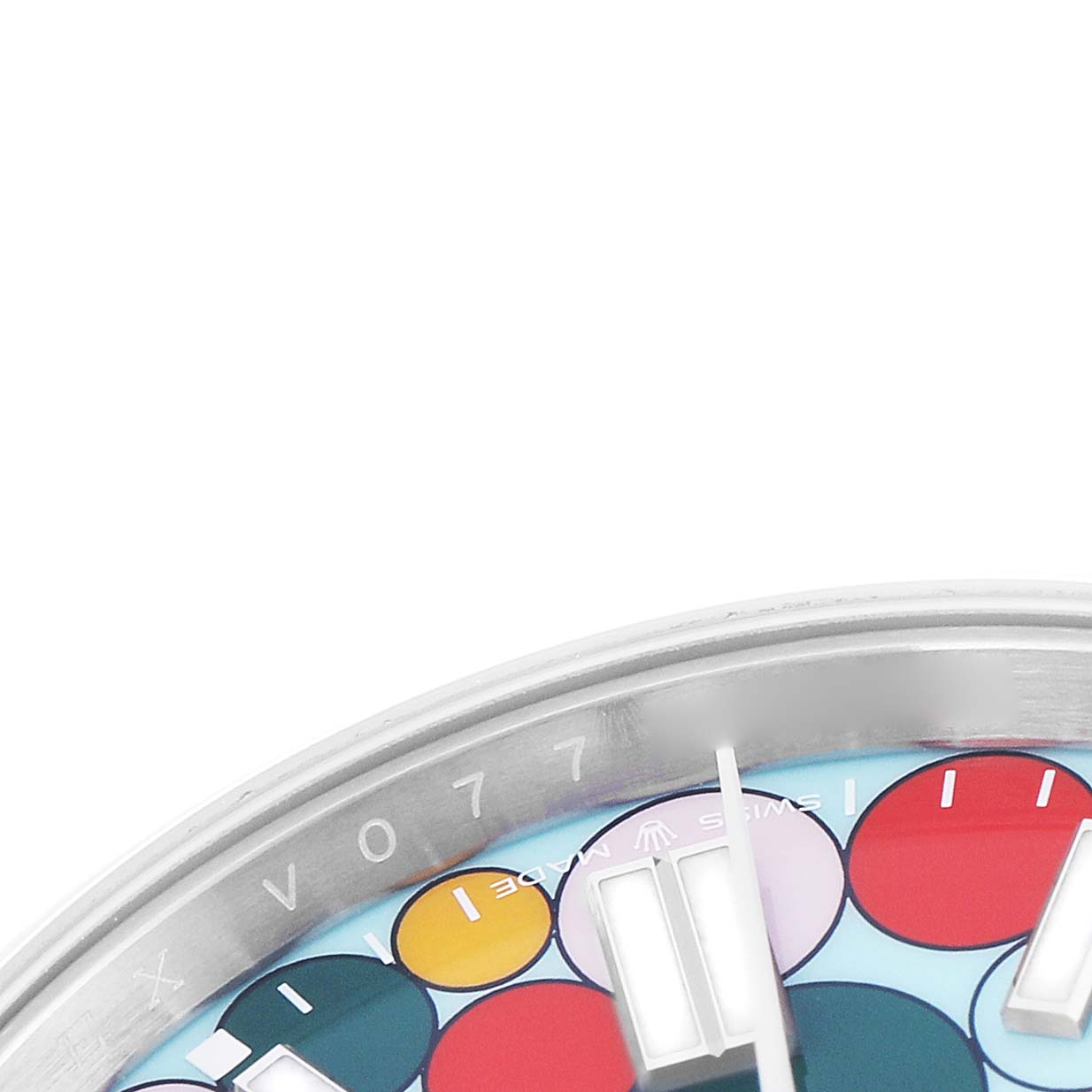 The image shows the upper half of the Rolex Oyster Perpetual 124300 Men
s Stainless Steel Blue Dial watch face at an angle, highlighting the colorful dial and bezel edge.