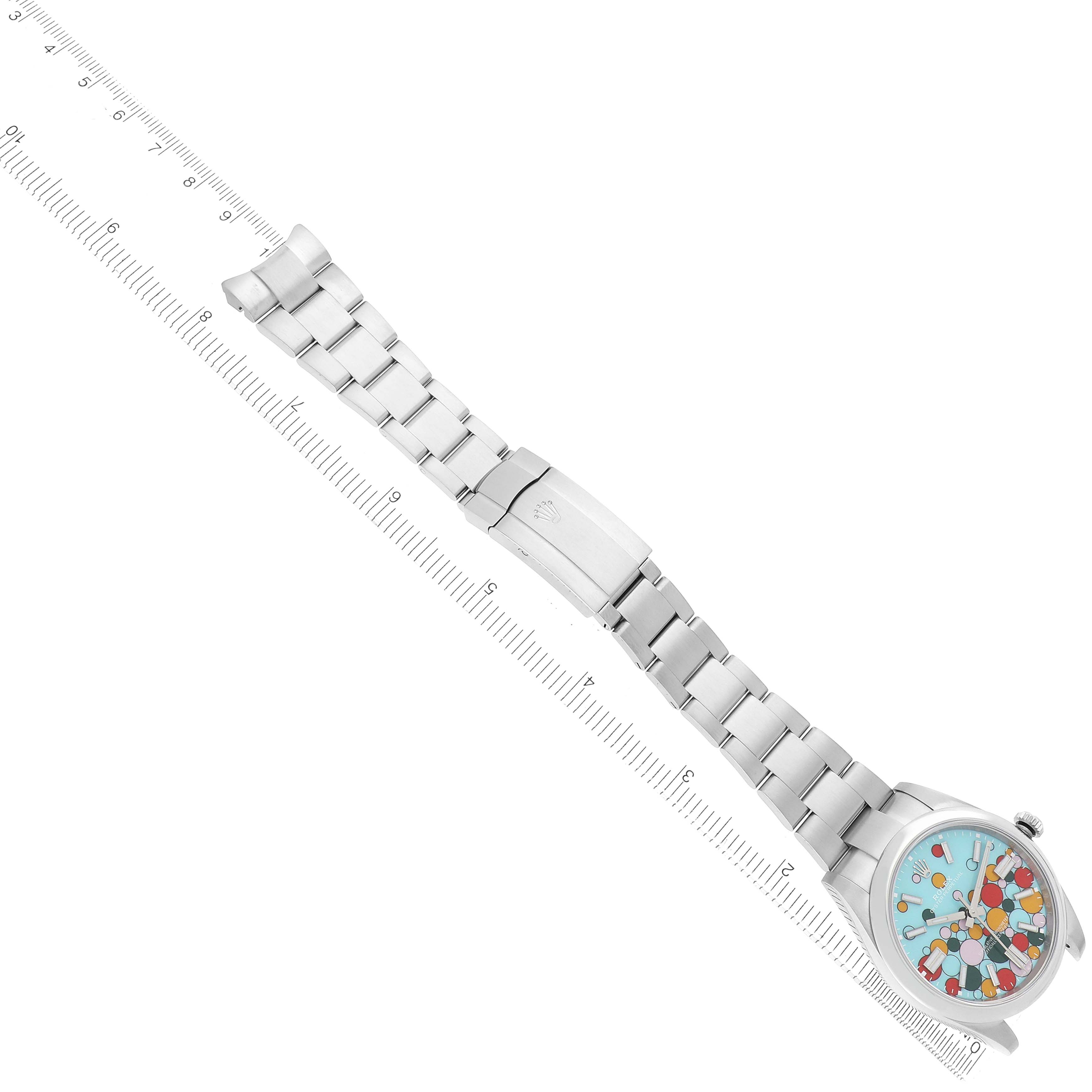 The Rolex Oyster Perpetual 124300 Men
s Stainless Steel Blue Dial watch is shown at an angle displaying its entire bracelet and the colorful dial.