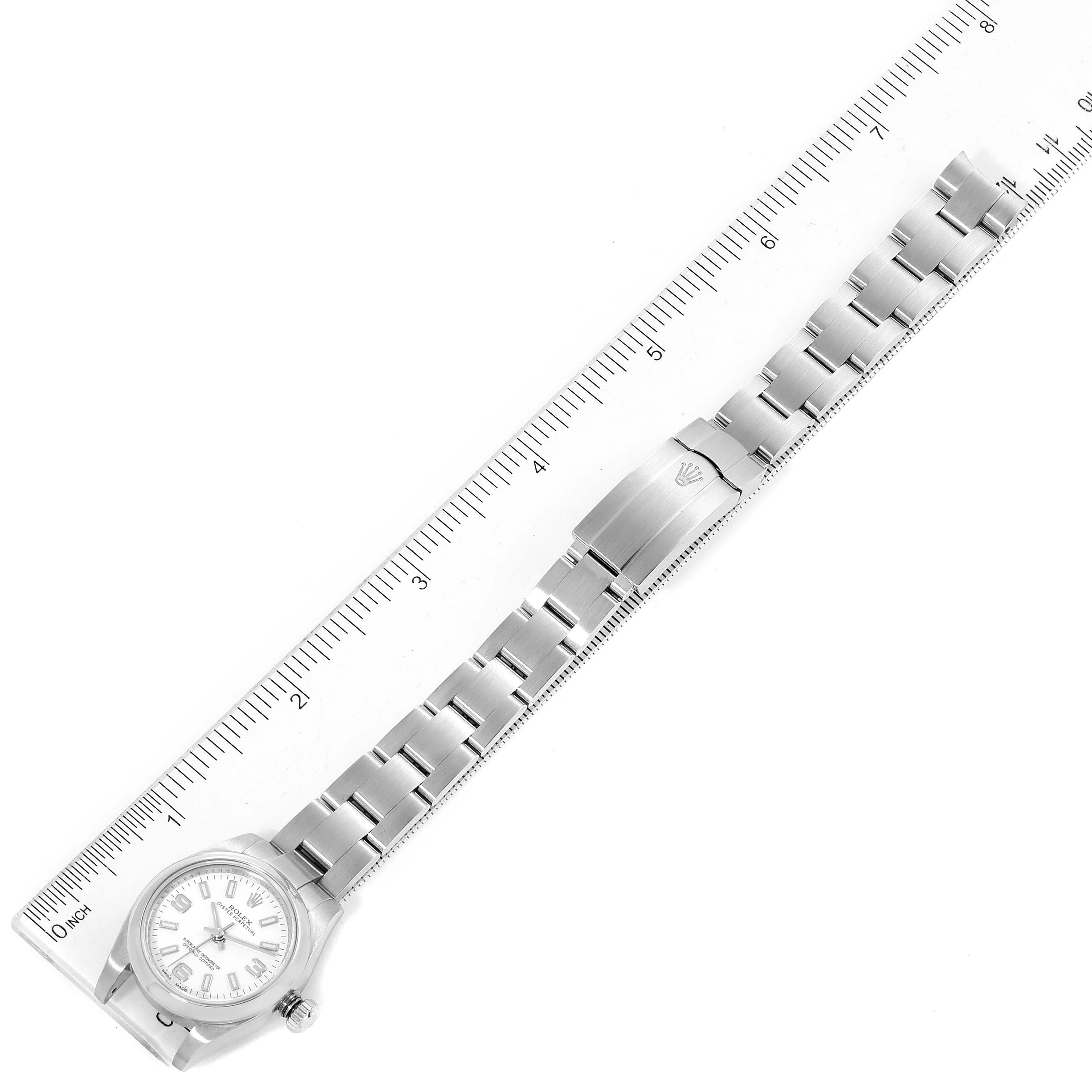 The image shows a Rolex Oyster Perpetual 176200 Women's Stainless Steel White Dial 176200 Women's Stainless Steel White Dial watch laid flat with a ruler beside it, highlighting its band and face.