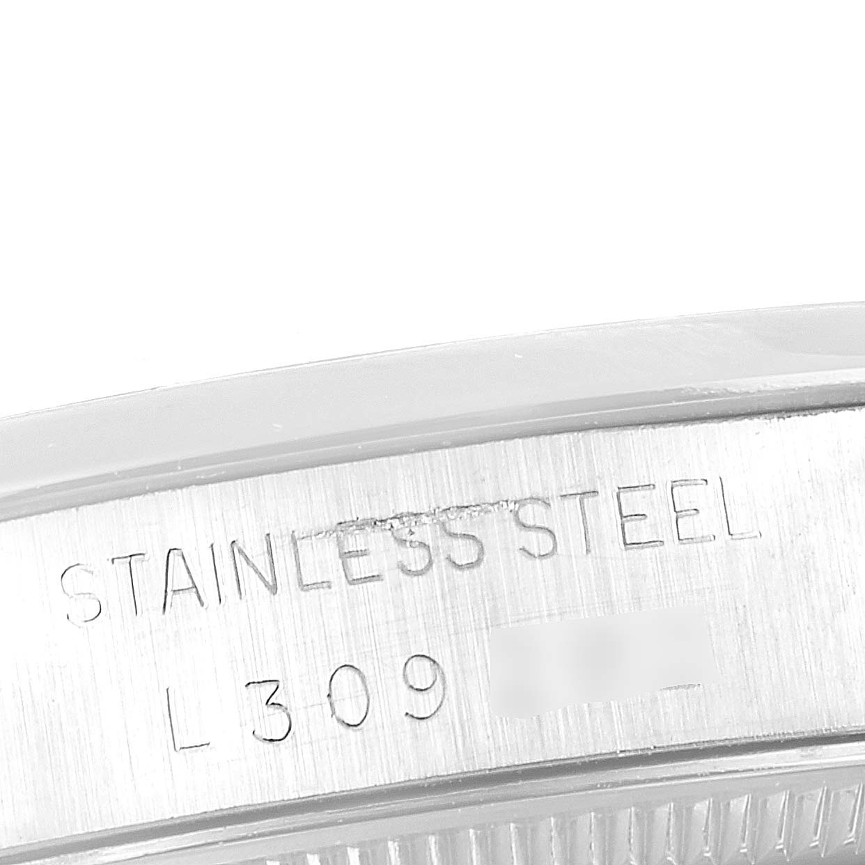 This image shows a close-up of the stainless steel case back, likely from a Vintage Collection Rolex watch.
