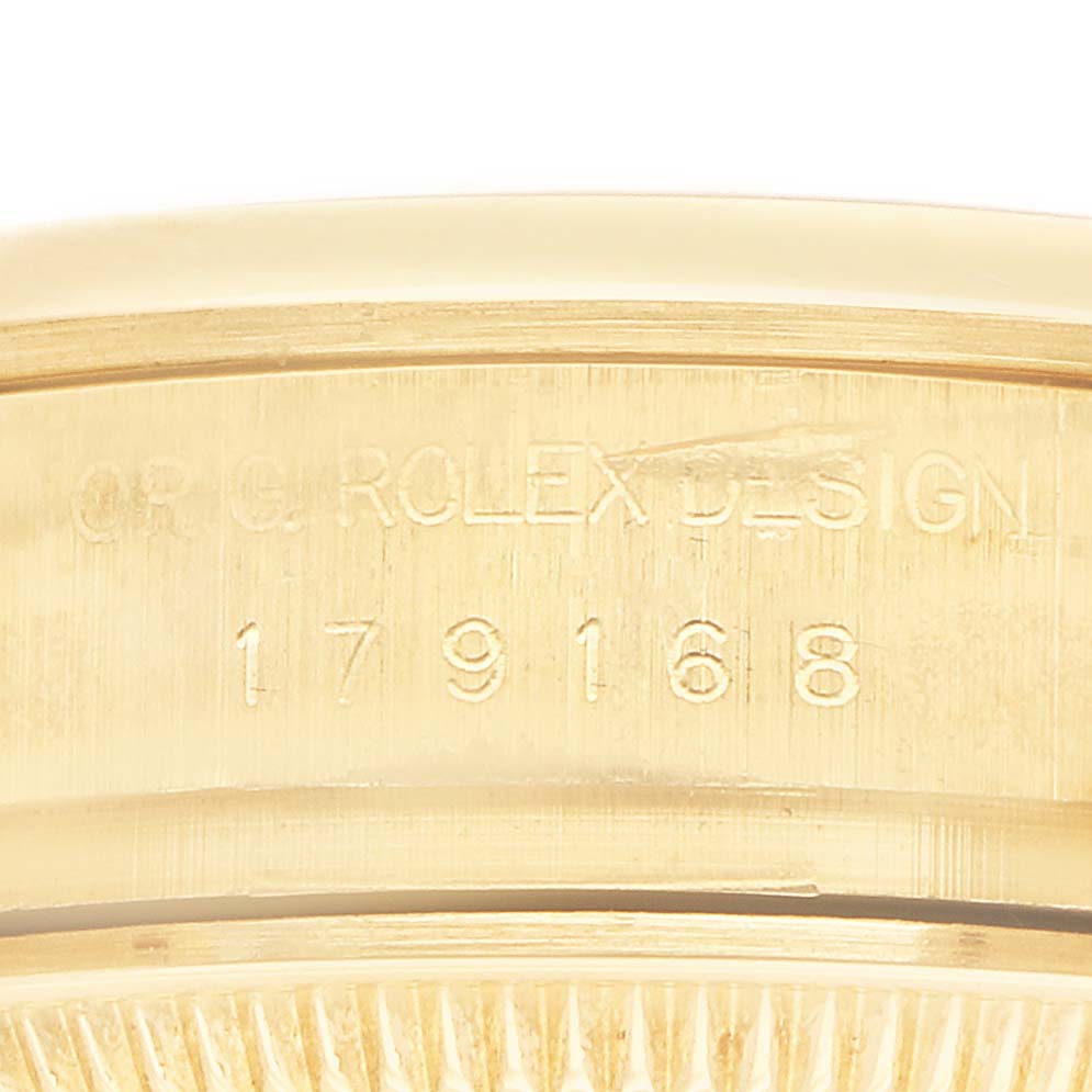 The image shows a close-up of the engraved side of a Rolex President 179168 Men
s Yellow Gold White Dial model watch case, displaying the model number.