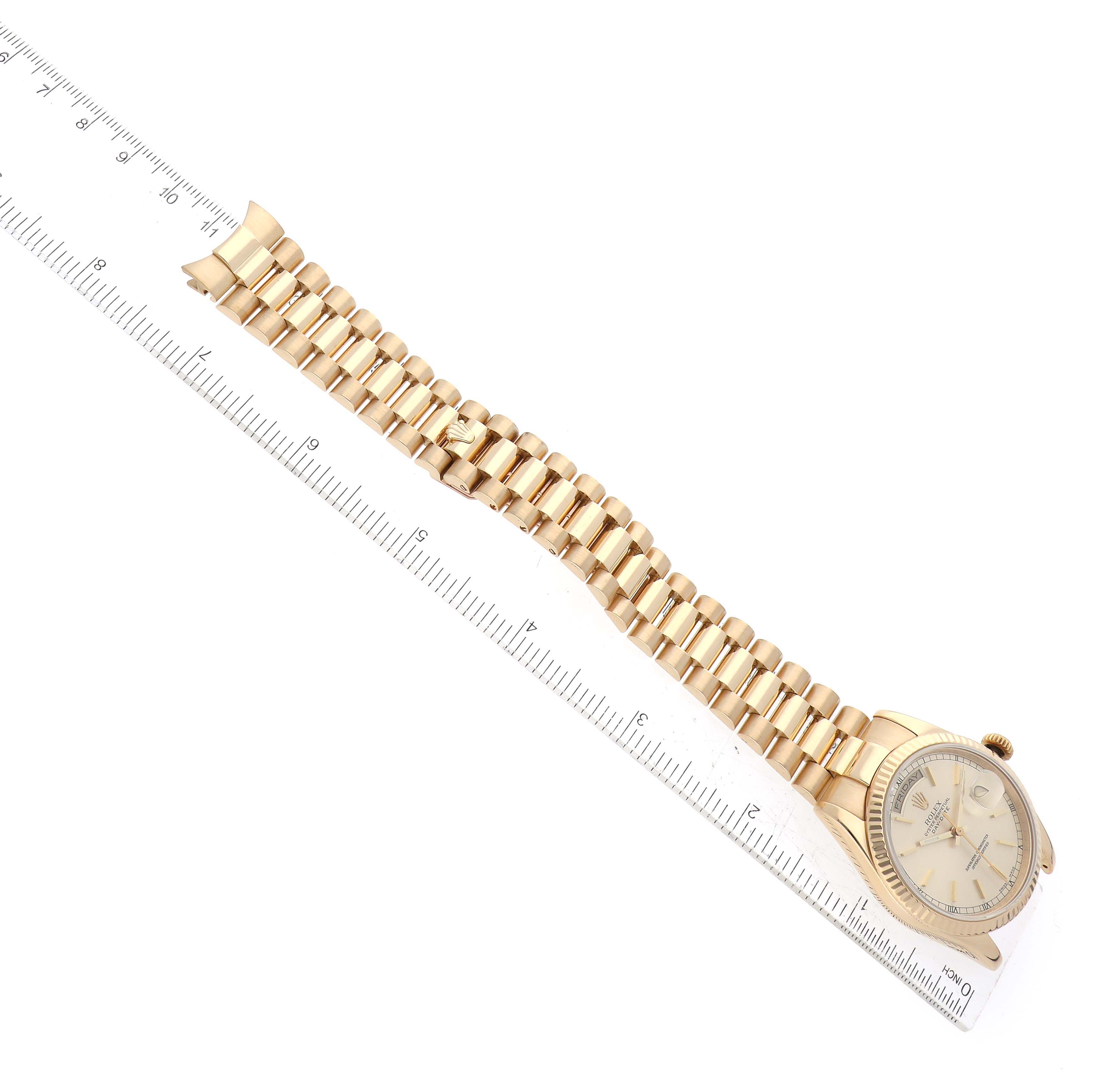 This image shows the Rolex President 118238 Men
s Yellow Gold Champagne Dial 118238 Men
s Yellow Gold Champagne Dial watch, displaying its full gold bracelet and dial alongside a ruler for measurement.