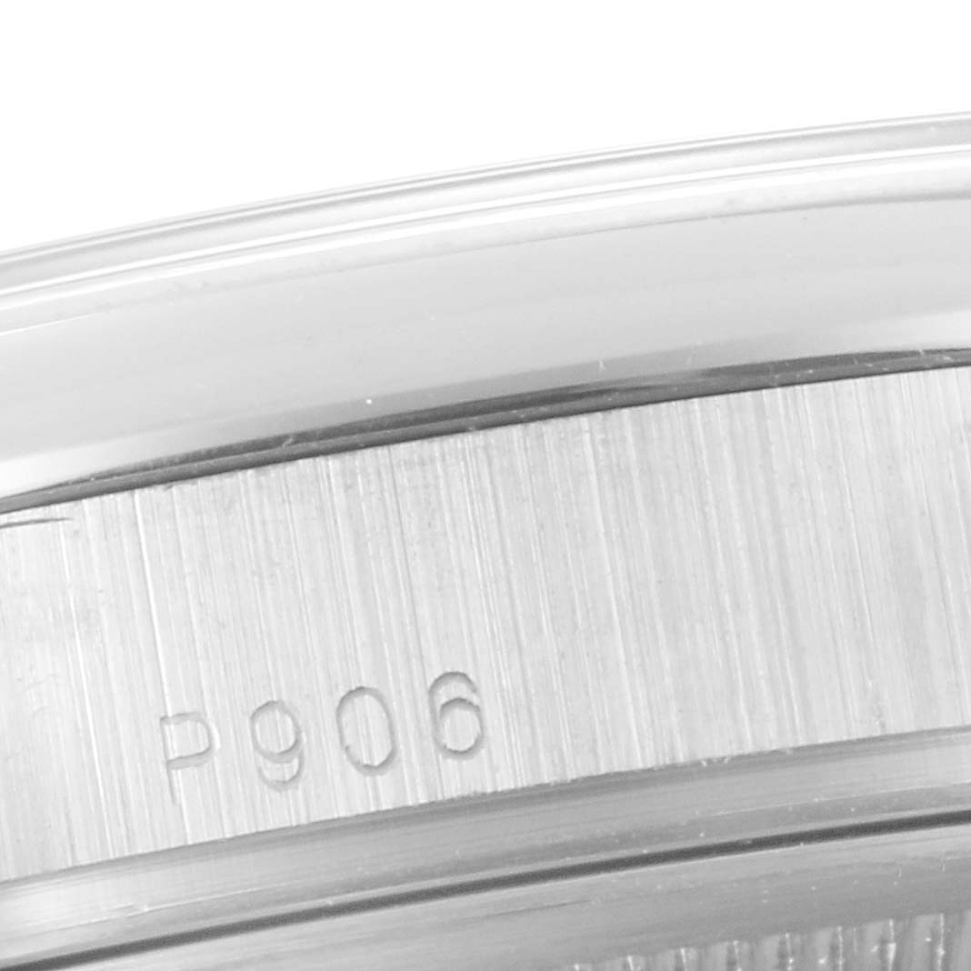 The image shows a close-up of the side edge and part of the bezel of a Rolex President 118206 Men's Platinum Blue Dial 118206 Men's Platinum Blue Dial watch with engraved markings.