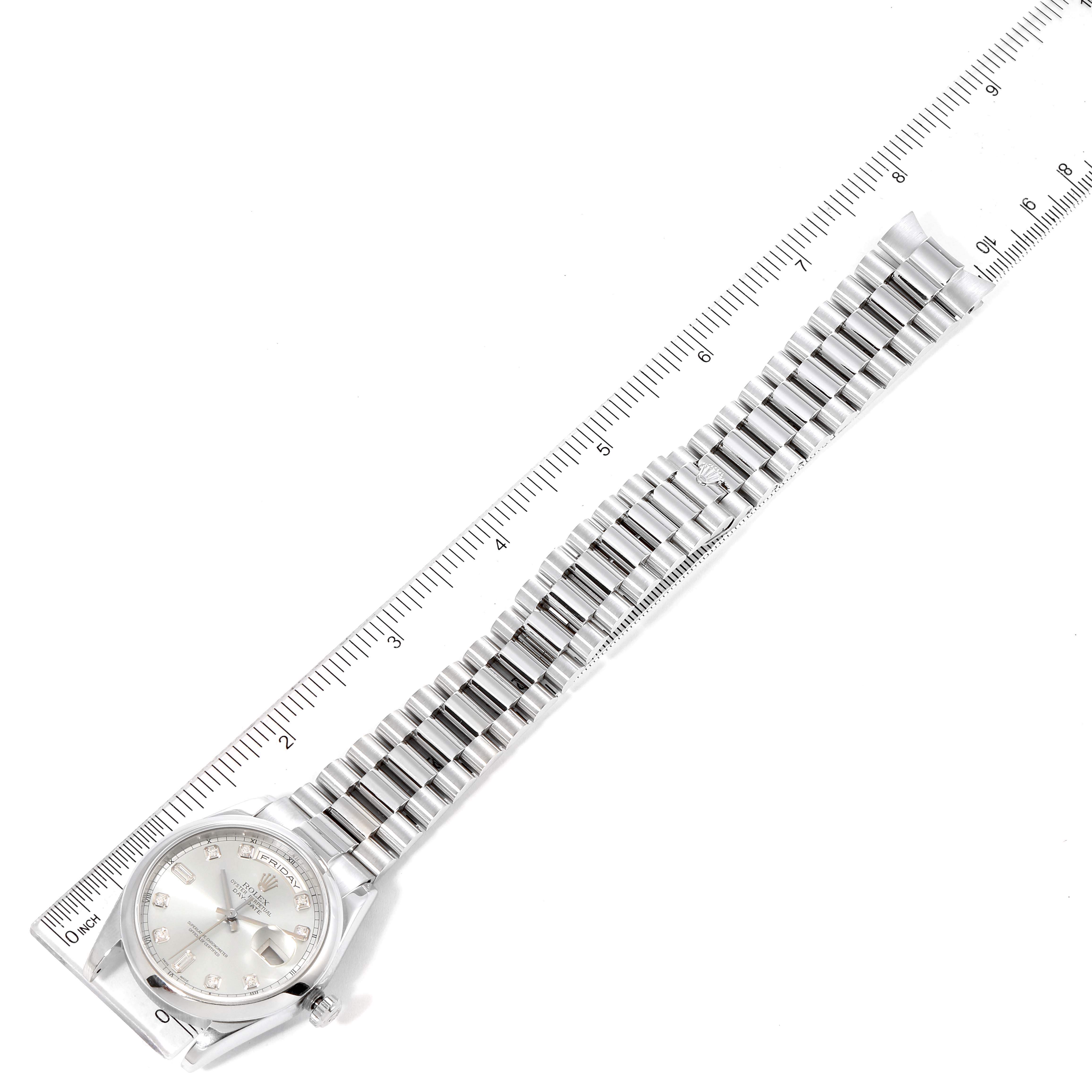 The image shows a top-down view of a Rolex President 118206 Men's Platinum Blue Dial 118206 Men's Platinum Blue Dial model watch, including the face and band next to a ruler.