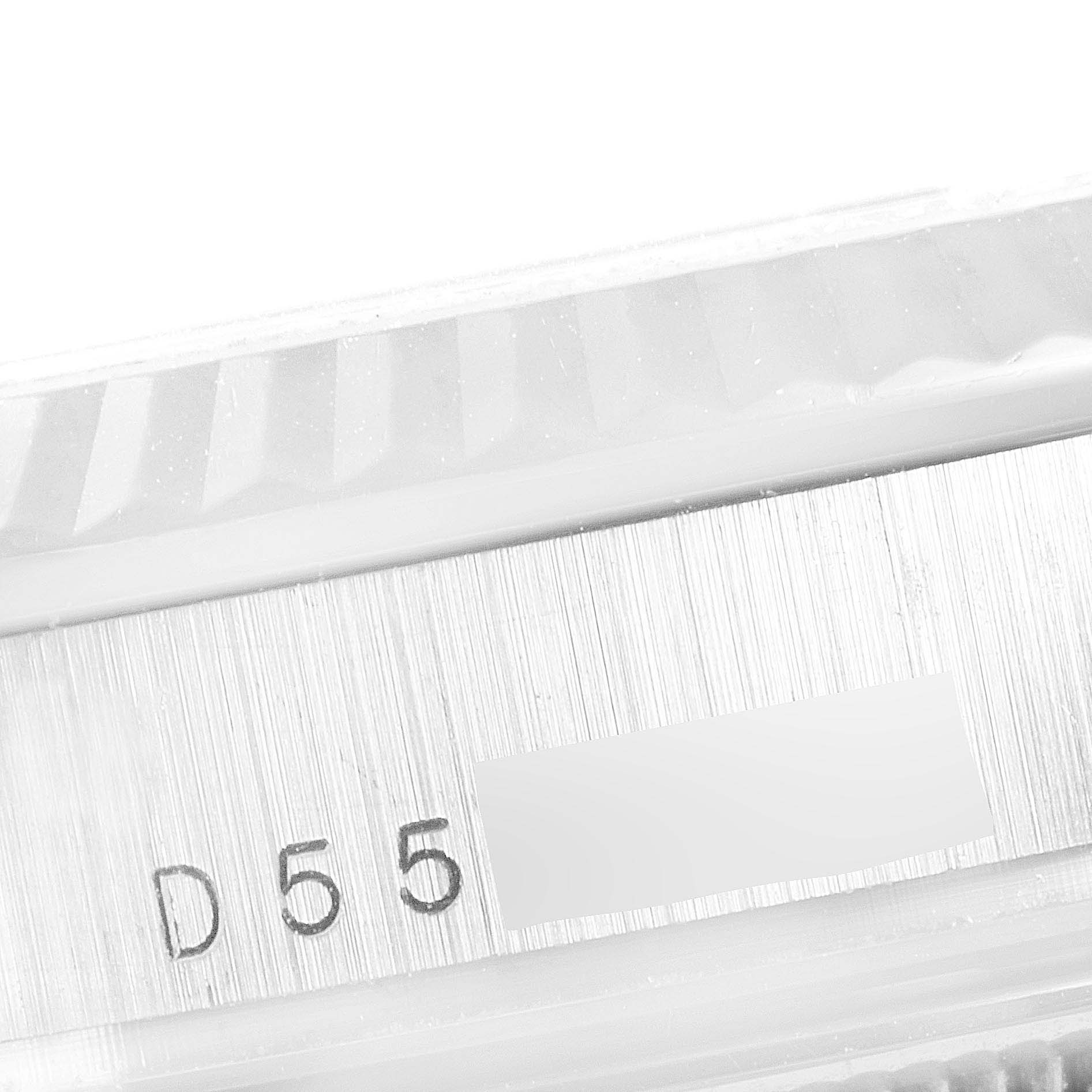 This close-up image of a Rolex President 118239 Men's White Gold Silver Dial 118239 Men's White Gold Silver Dial model watch shows the side edge, featuring the serial number and part of the fluted bezel.