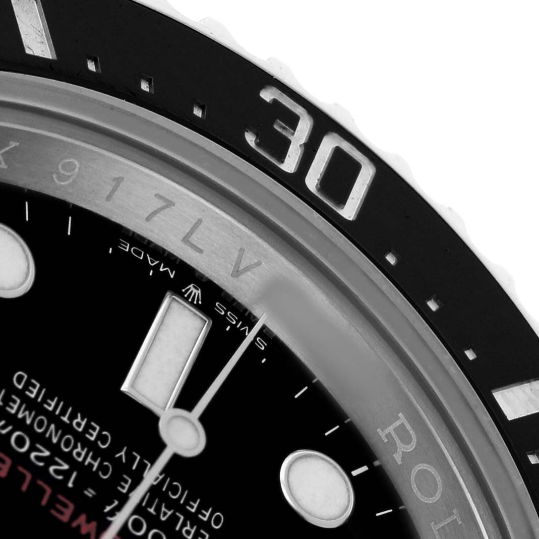 The image shows a close-up of the Rolex Sea-Dweller 126600 Men's Stainless Steel Black Dial's bezel, part of the dial, and some indices.