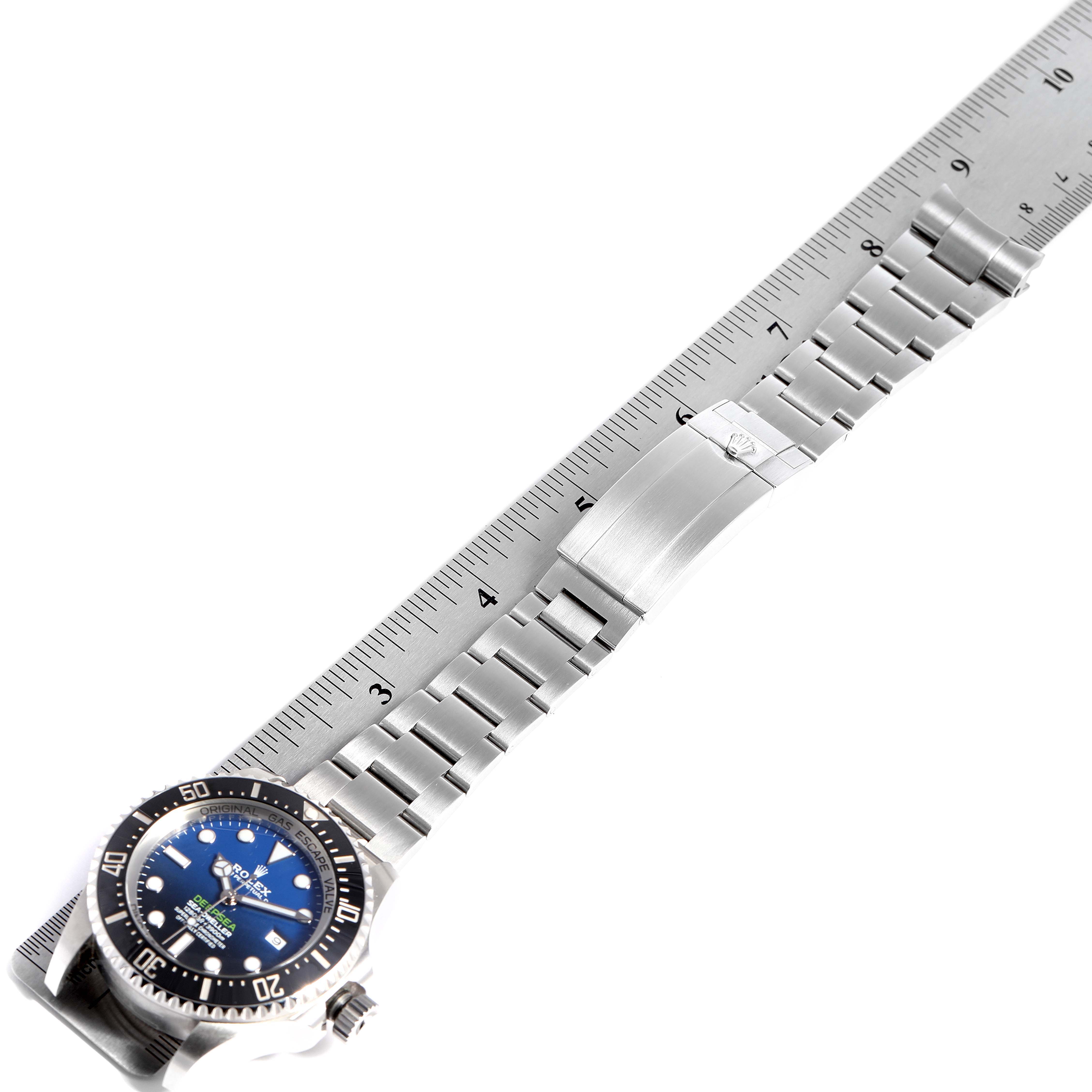 The image shows a side view of a Rolex Sea-Dweller 126660 Men
s Stainless Steel Blue Dial 126660 Men
s Stainless Steel Blue Dial watch, displaying the face, bracelet, and clasp alongside a ruler for scale.