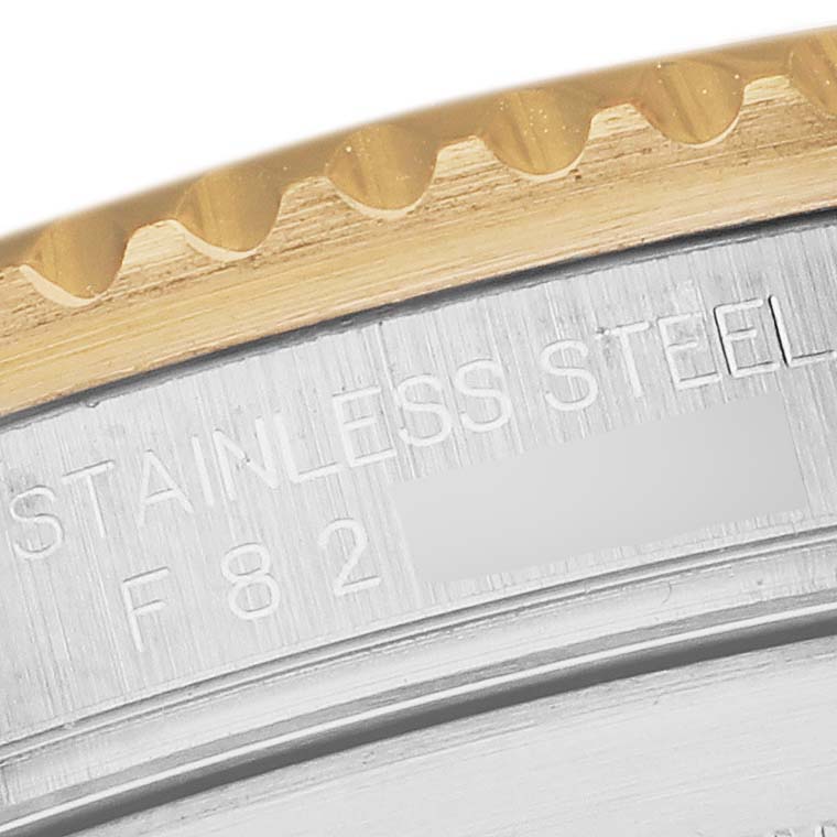 The image shows a detailed close-up of the bezel and case side of a Rolex Submariner 16613 Men's Steel and Gold (two tone) Blue Dial 16613 Men's Steel and Gold (two tone) Blue Dial, highlighting the engraving "STAINLESS STEEL".