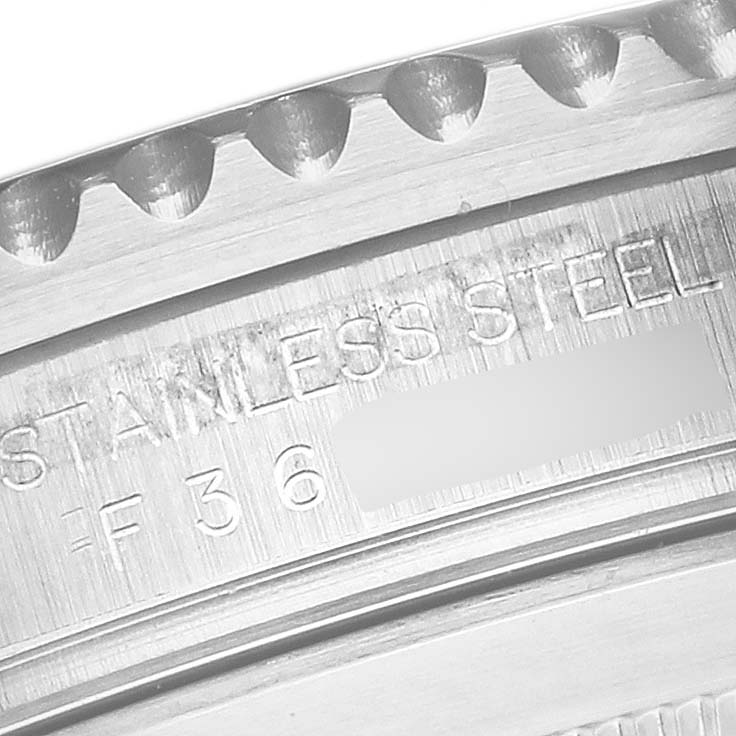 This close-up image shows the engraved bezel and part of the case of a Rolex Submariner 16610 Men's Stainless Steel Black Dial 16610 Men's Stainless Steel Black Dial.