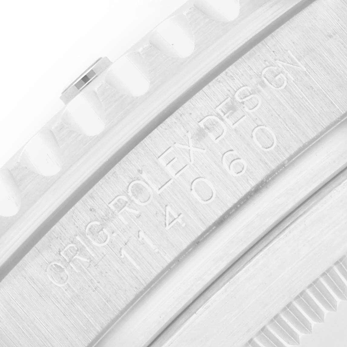 The image shows a close-up of the engraved bezel and edge detail of a Rolex Submariner 114060 Men's Stainless Steel Black Dial watch.