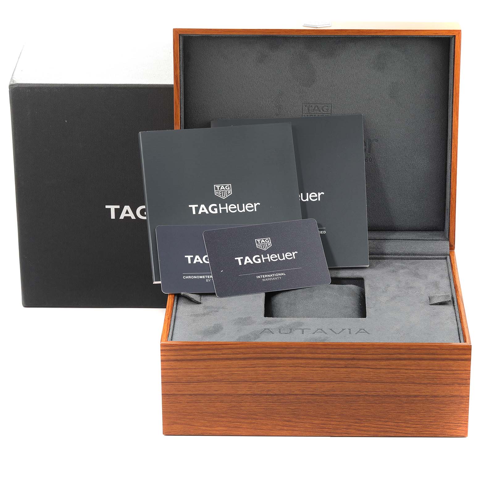 The image shows the packaging and accessories for a Tag Heuer Autavia CBE511B.FC8279 Men's Stainless Steel Black Dial CBE511B.FC8279 Men's Stainless Steel Black Dial watch, including manuals and warranty cards, but no watch.