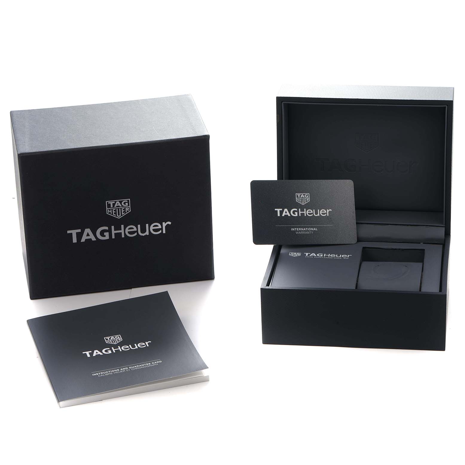 The image shows the packaging and accessories of a Tag Heuer Carrera CAR2A1H Men
s Stainless Steel Transparent Dial watch, including the box, warranty card, and manual.