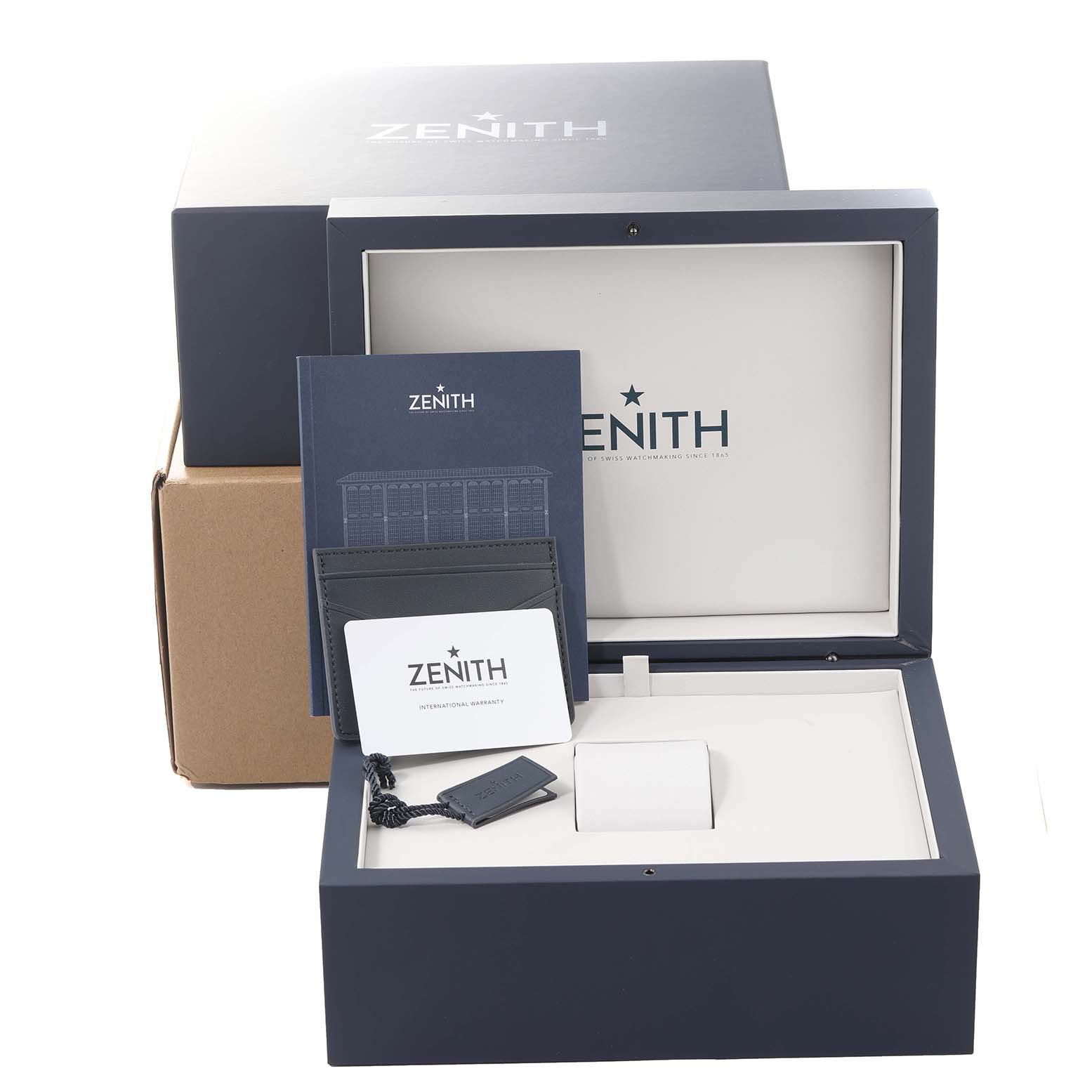 The image shows the packaging and accessories for the Zenith Chronomaster 03.3100.3600/21.C822 Men's Stainless Steel Black Dial 03.3100.3600/21.C822 Men's Stainless Steel Black Dial watch, including the box, manual, and warranty card.