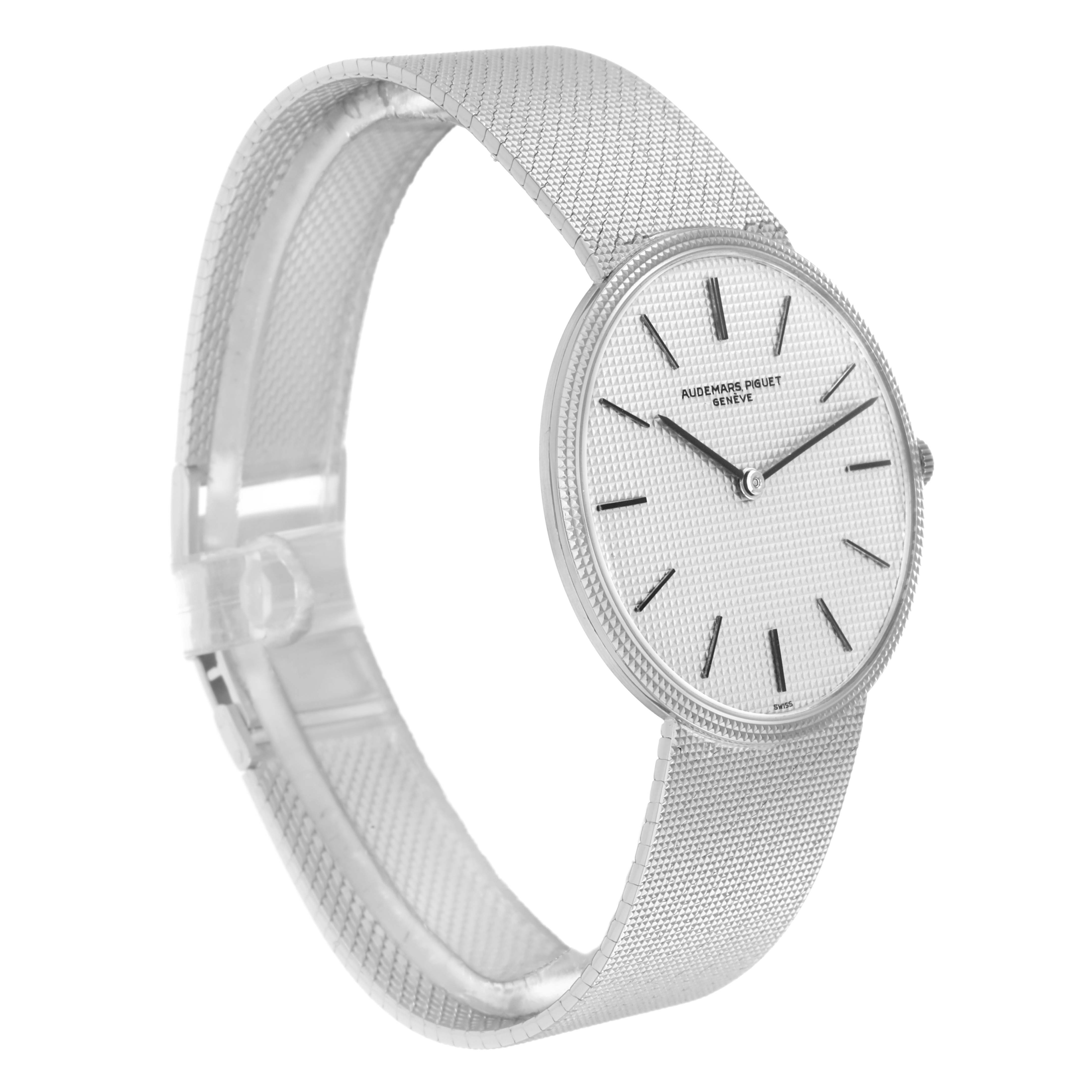 The Audemars Piguet Vintage Men
s White Gold Silver Dial watch is shown at a three-quarter angle, highlighting its textured dial, slim hands, and elegant band.